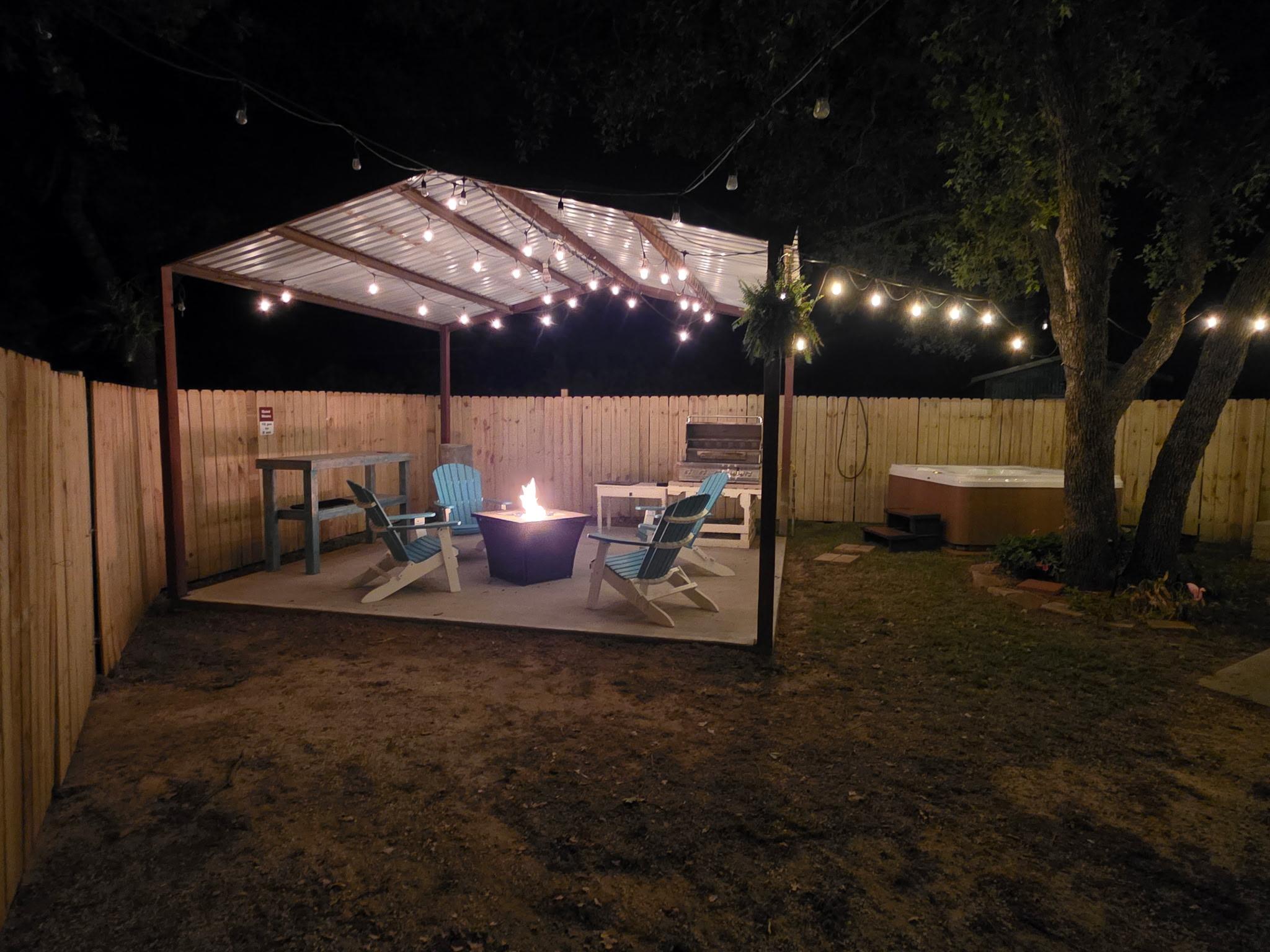 A tray of champagne on a bed with ice and pine branches.
