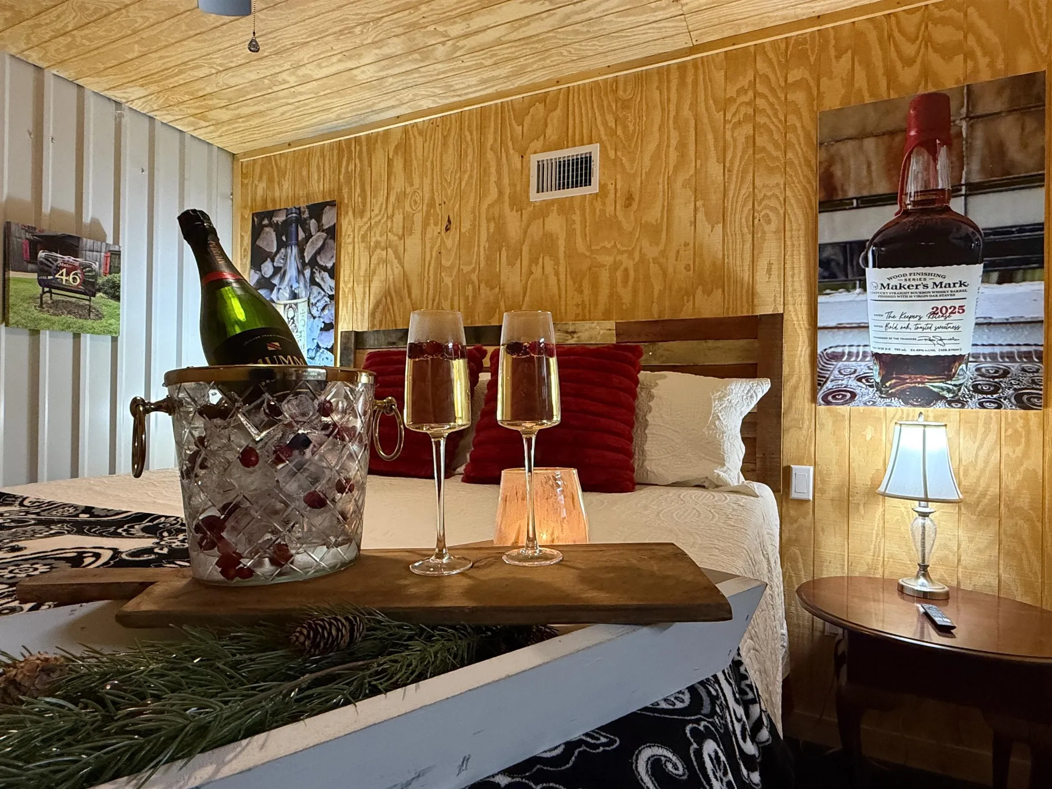 Two beds with white quilted comforters and blue pillows are in a room with wood paneling and a black