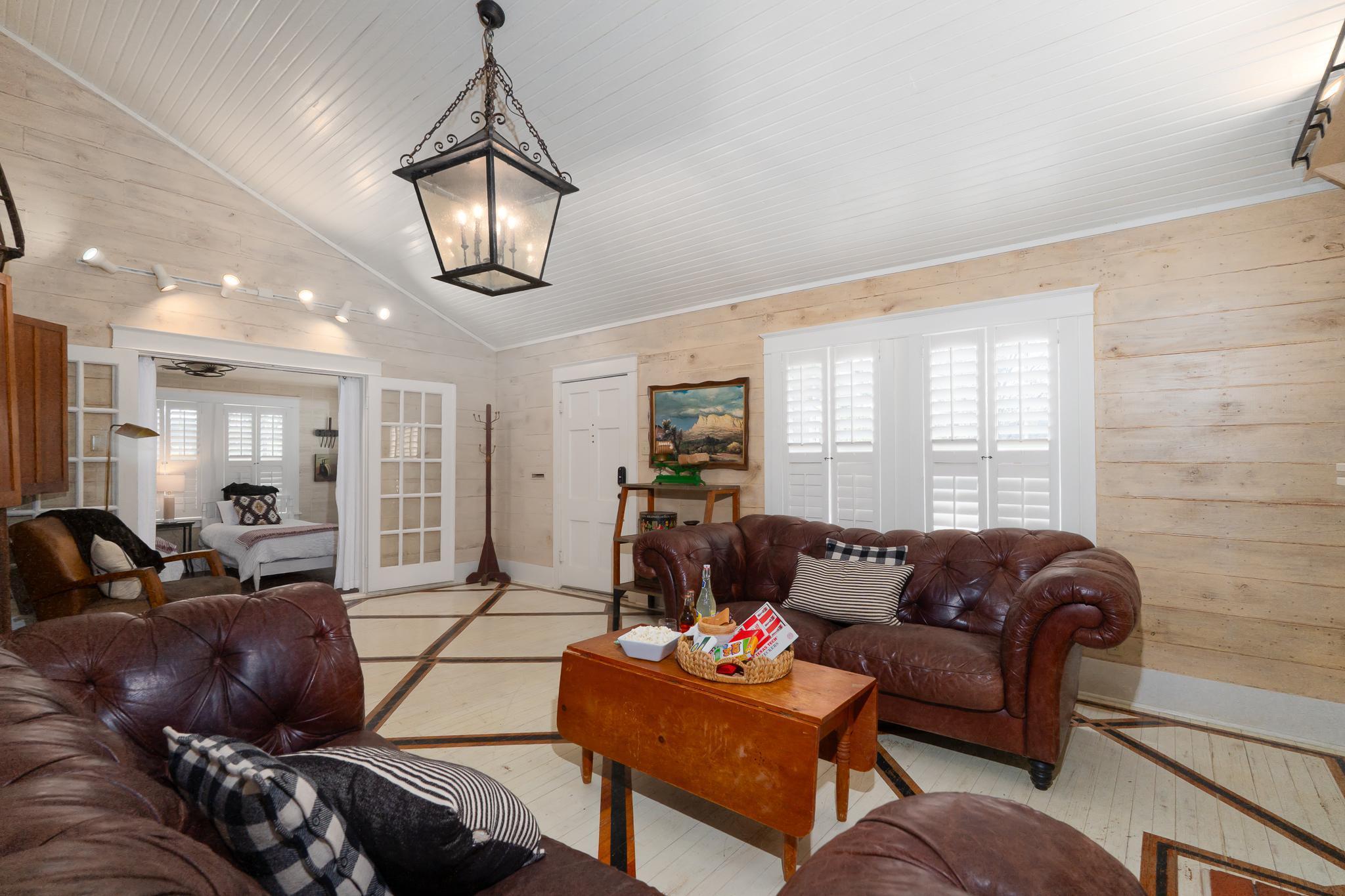 Nighttime backyard patio scene with string lights and a fire pit.