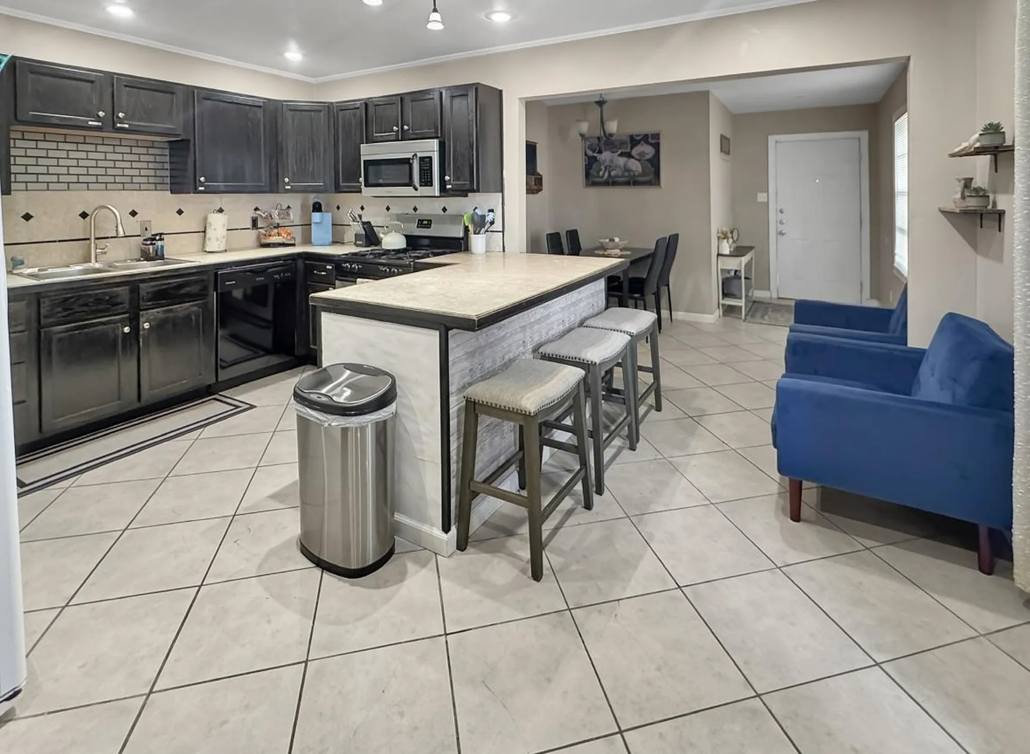 A bedroom with two twin beds, galaxy-themed bedding, and astronaut pillows.