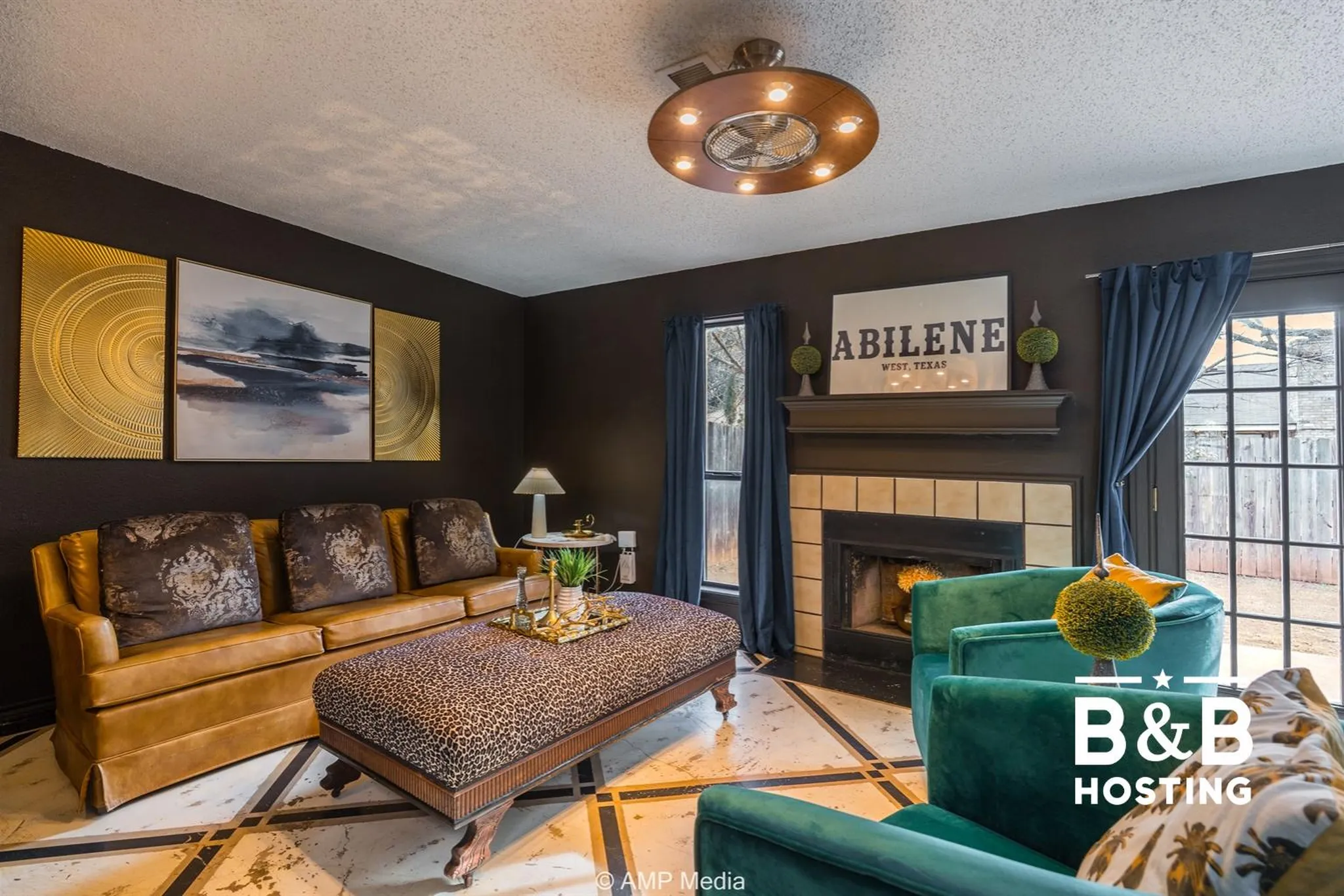 A living room with a brown sofa, cheetah print ottoman, and teal armchairs.