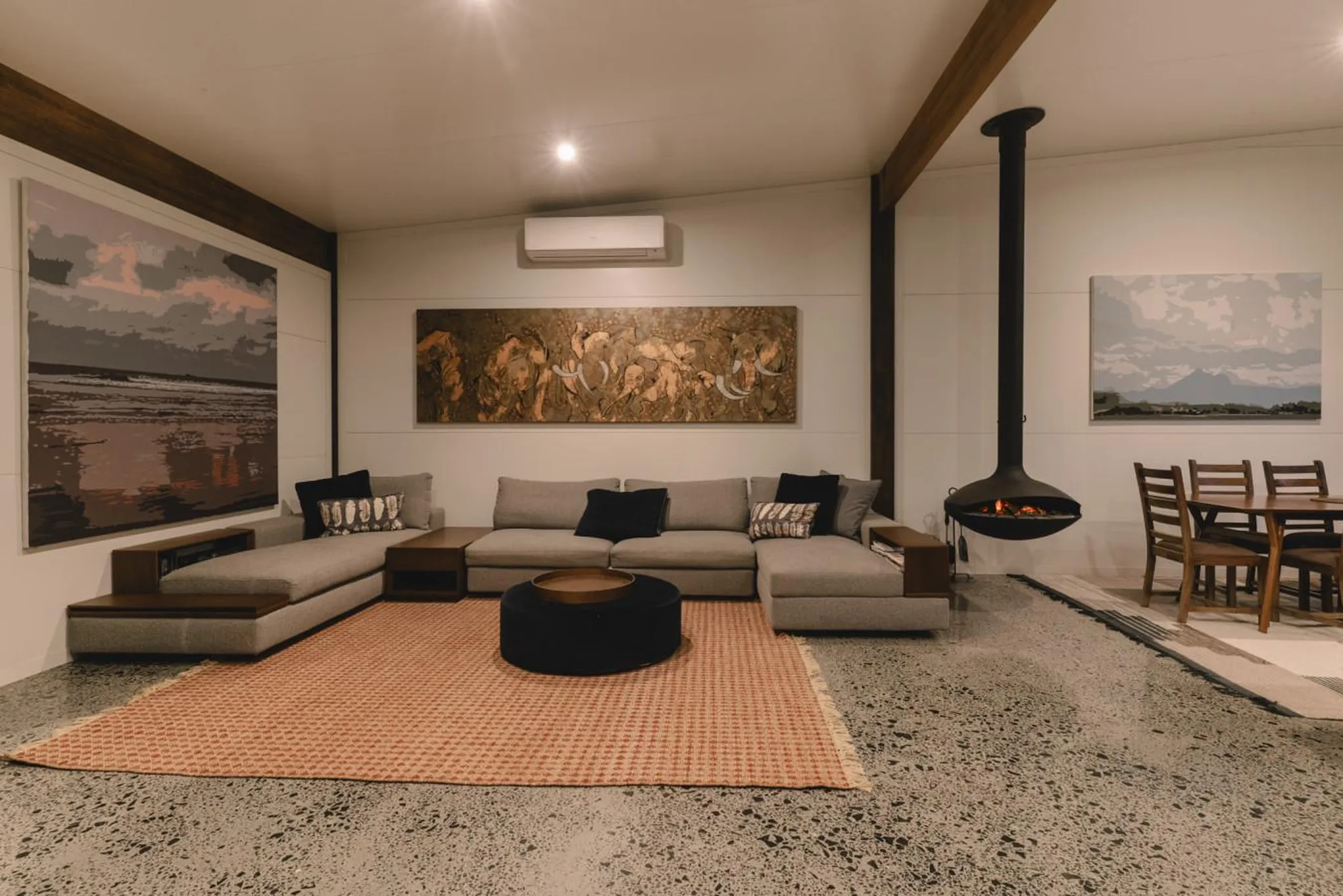 Living room with a sectional sofa, fireplace, and dining area.