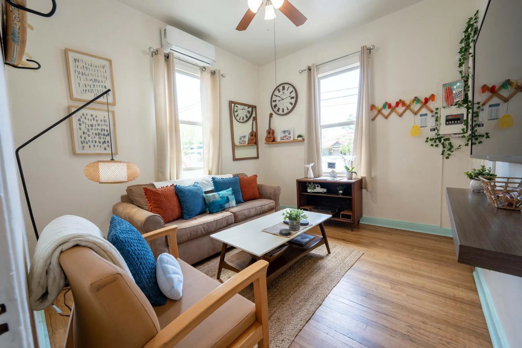 A living room with a sofa, coffee table, chairs, and decor.