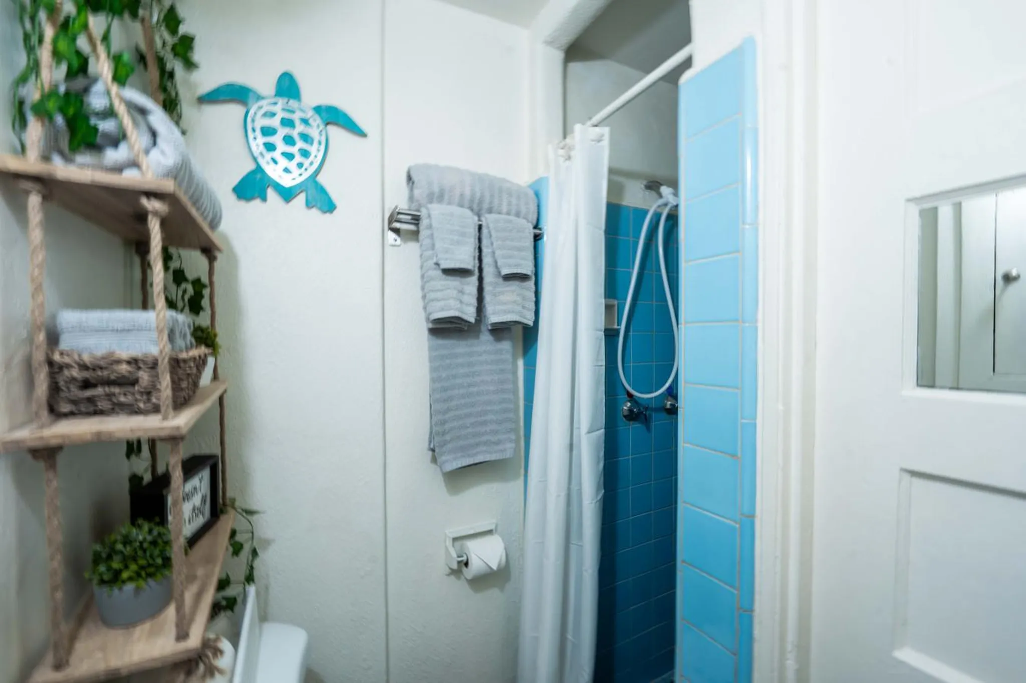 A bathroom with a shower and a towel rack.