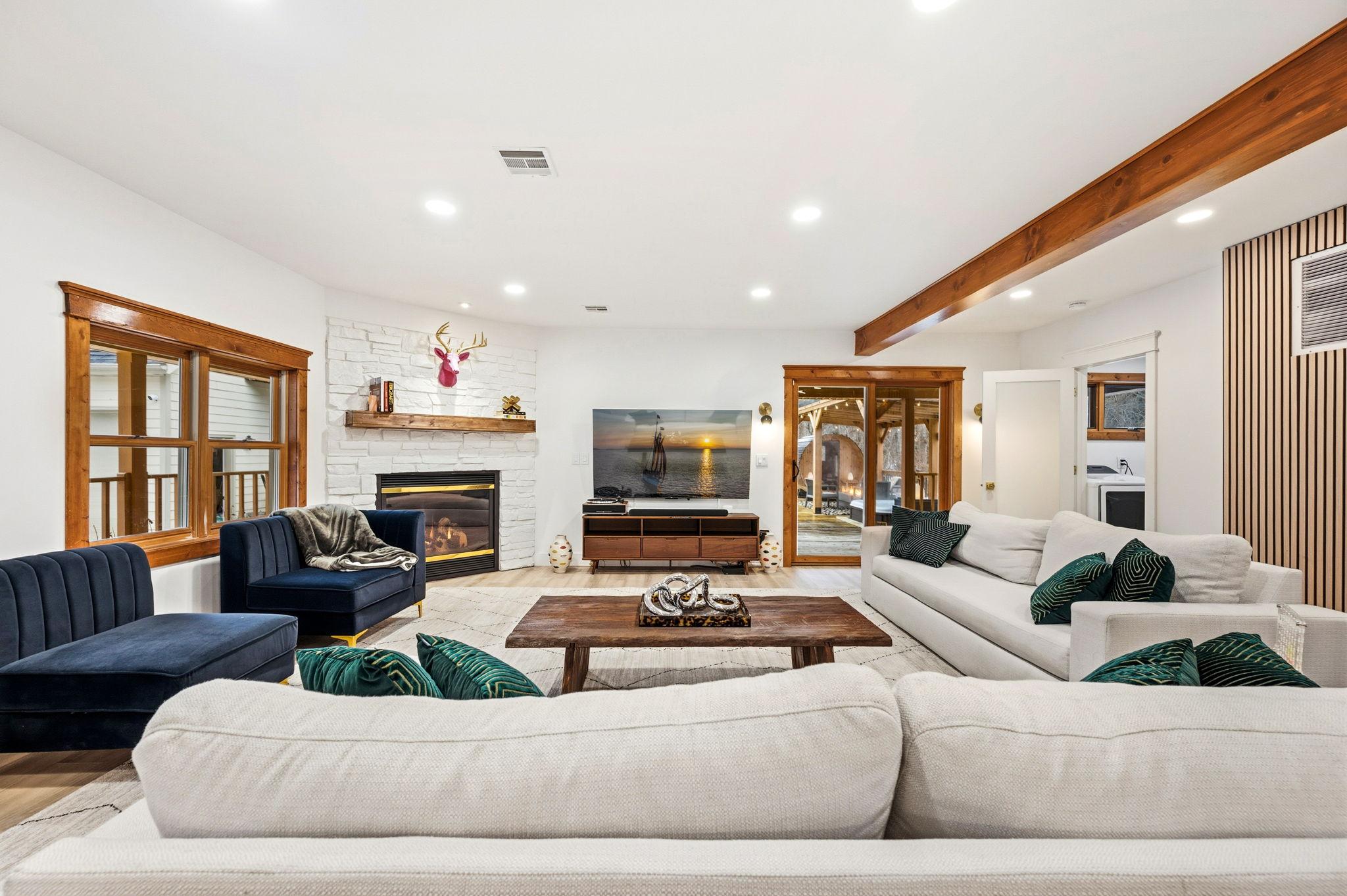 Living room with fireplace, TV, seating, and coffee table.