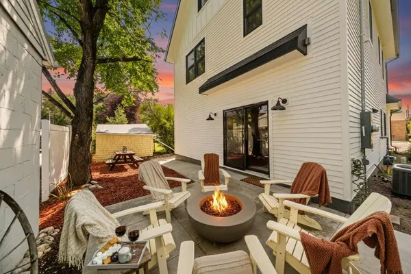 Back patio with a fire pit and Adirondack chairs at The Pearl of Sheridan