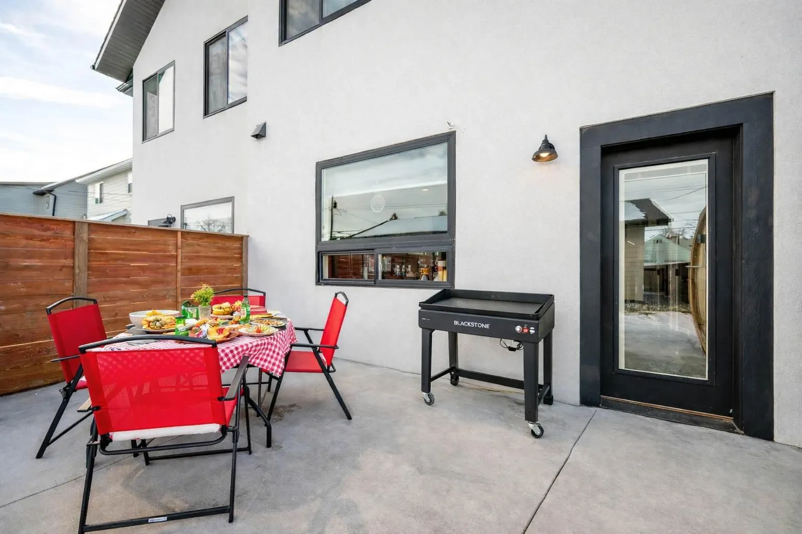 Backyard patio with seating and grill at The Zen Den