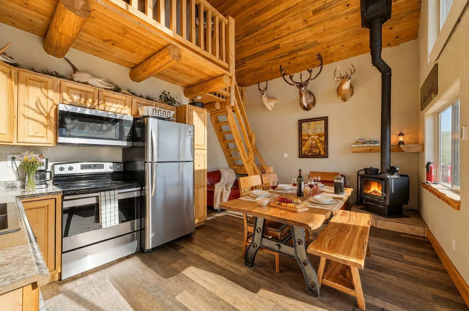 Kitchen, dining area, and fireplace inside Piton cabin in the Bighorn Mountains, Wyoming