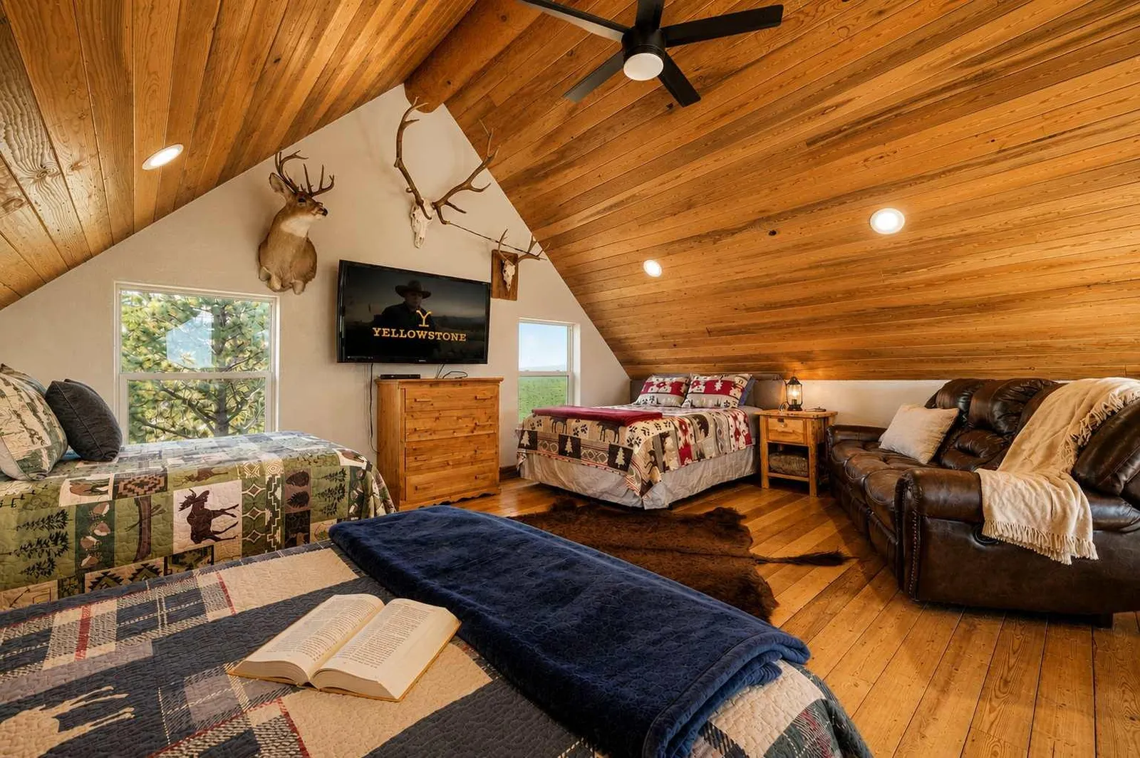 Loft at Piton cabin with sleeping beds and leather couch, Bighorn Mountains, Wyoming