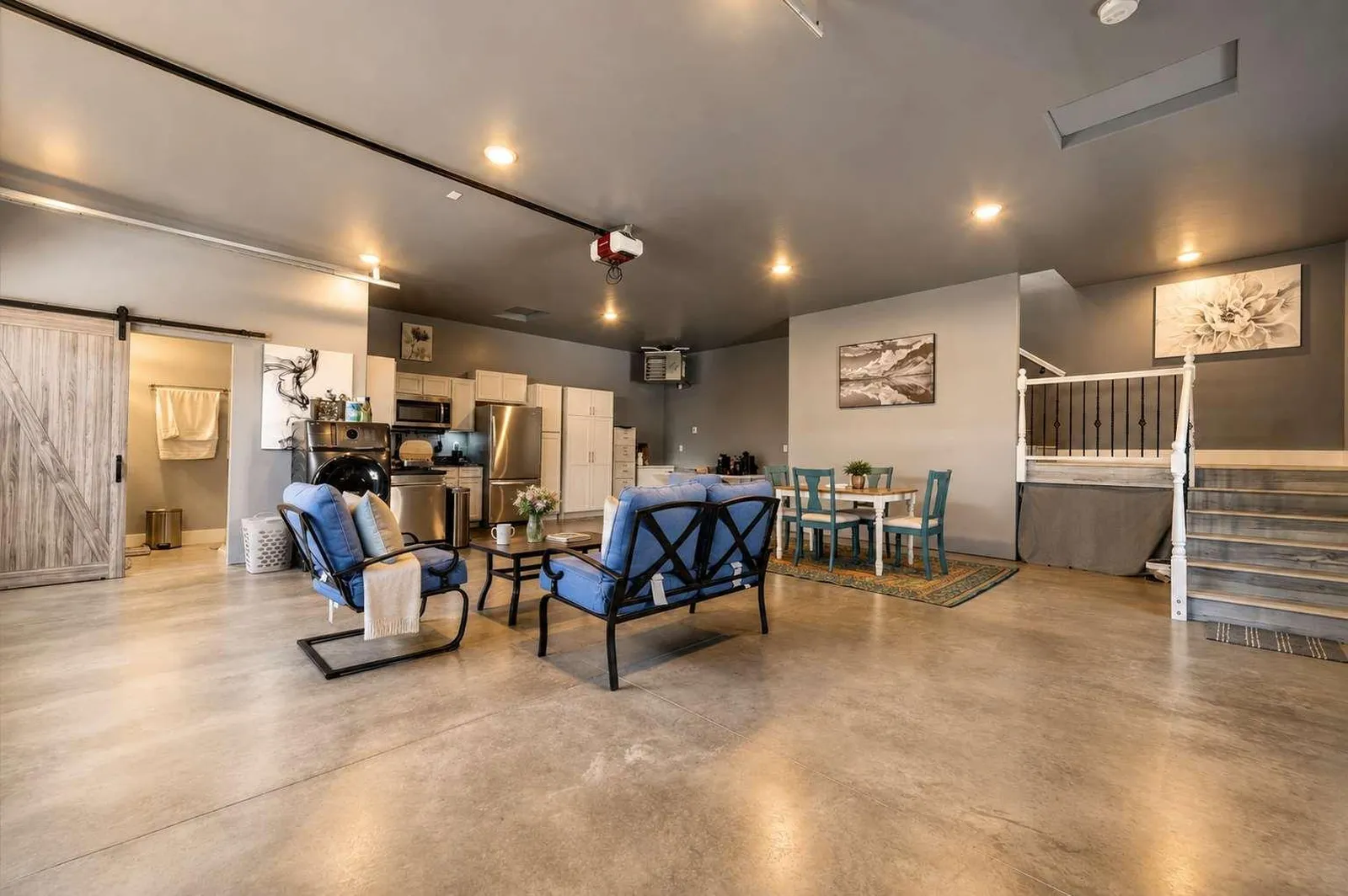 Open living area and kitchen at The Carriage Loft in Sheridan Wyoming with seating and dining table