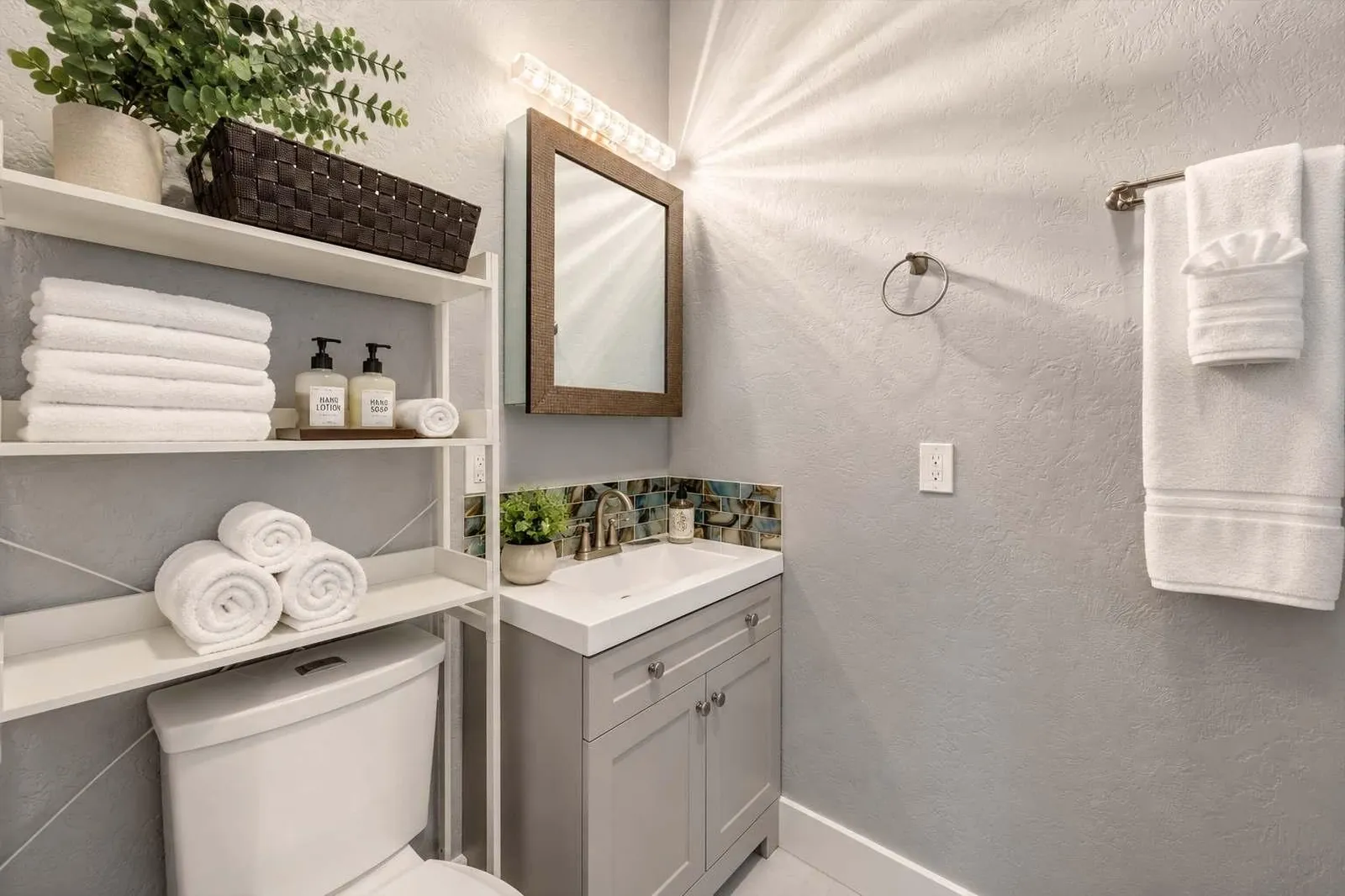 The Carriage Loft bathroom vanity with bright lighting and clean amenities in Sheridan WY