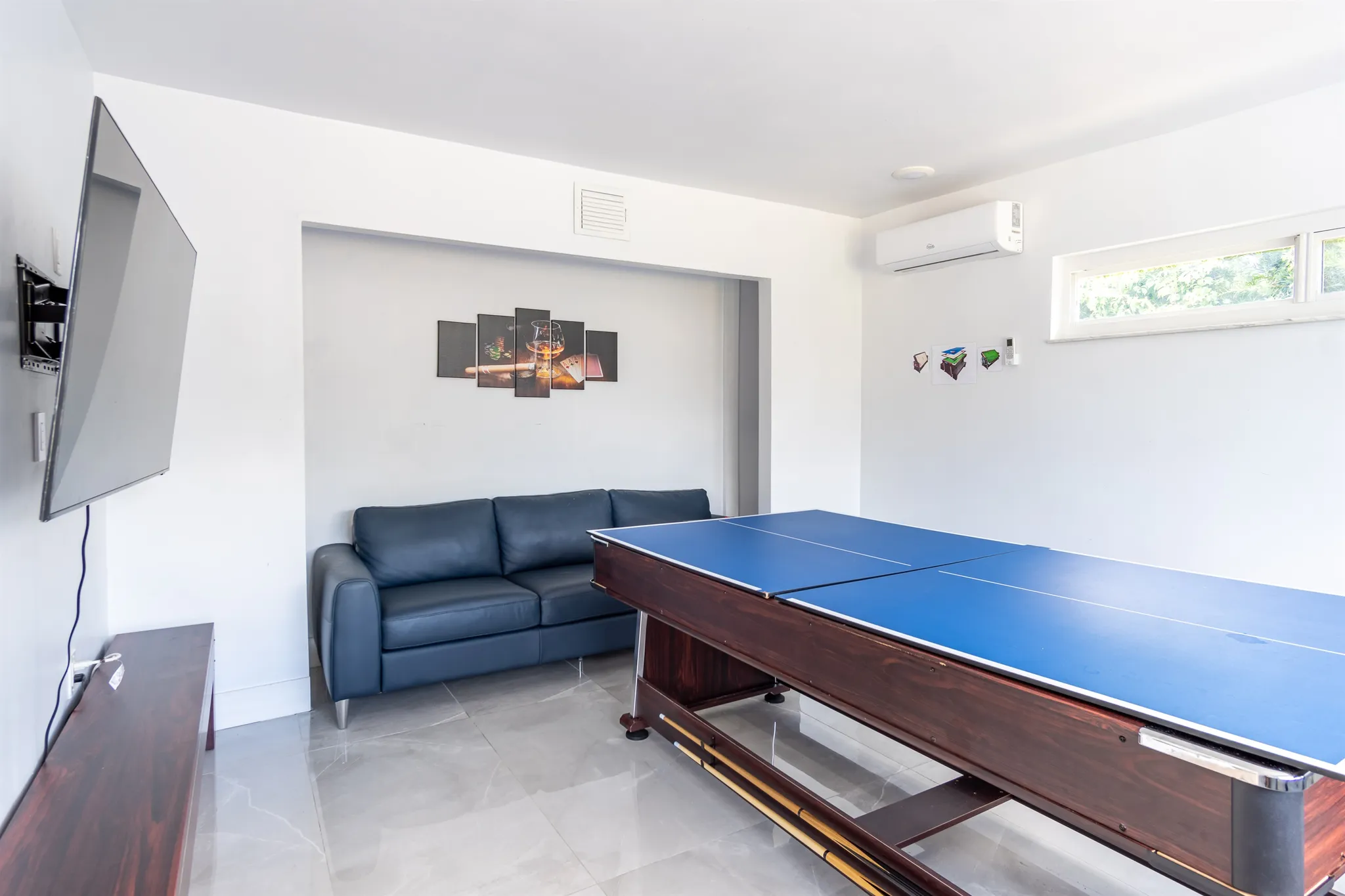 Game room with a pool table and lounge seating