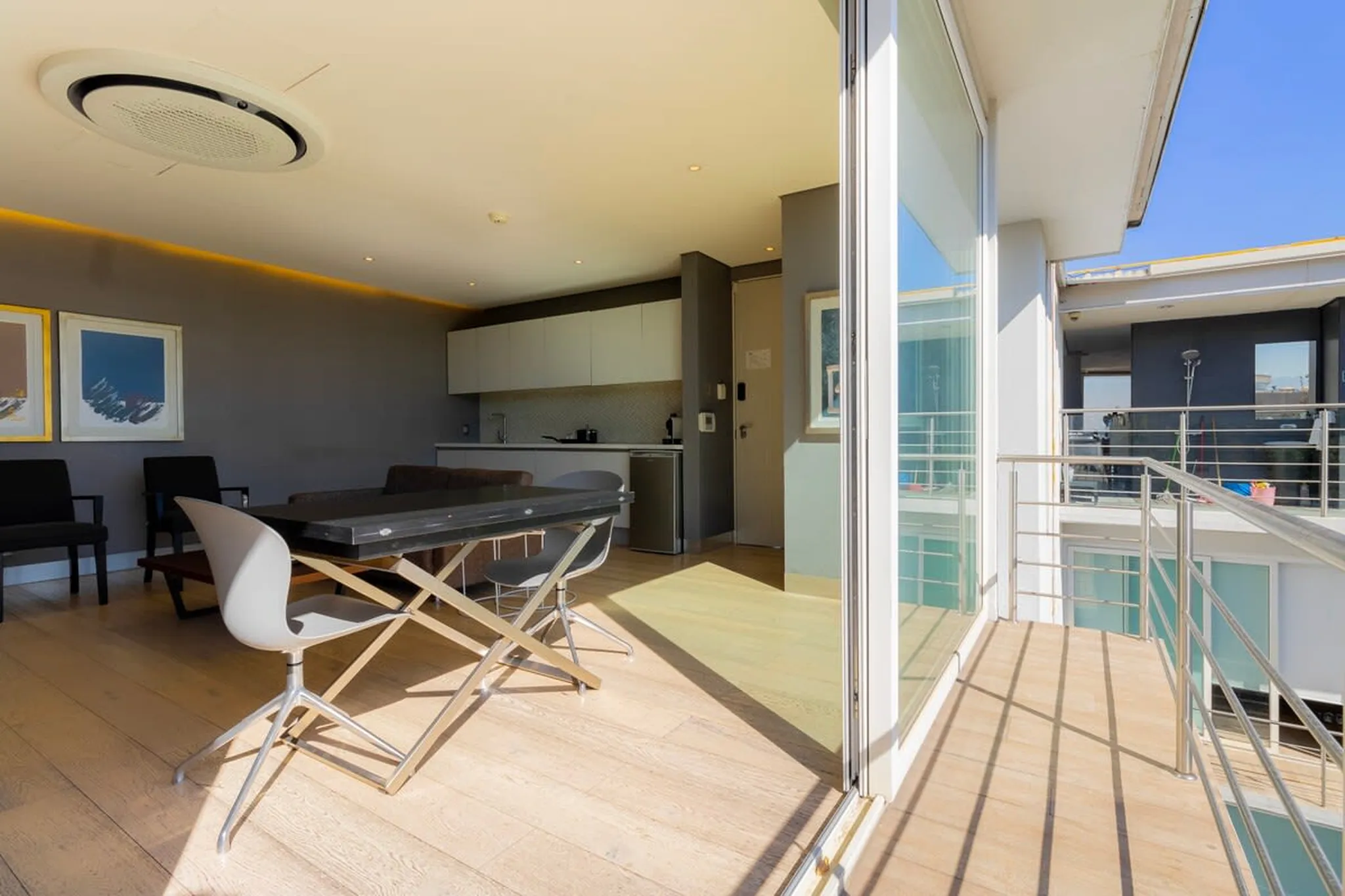Modern living room with dining area and balcony.
