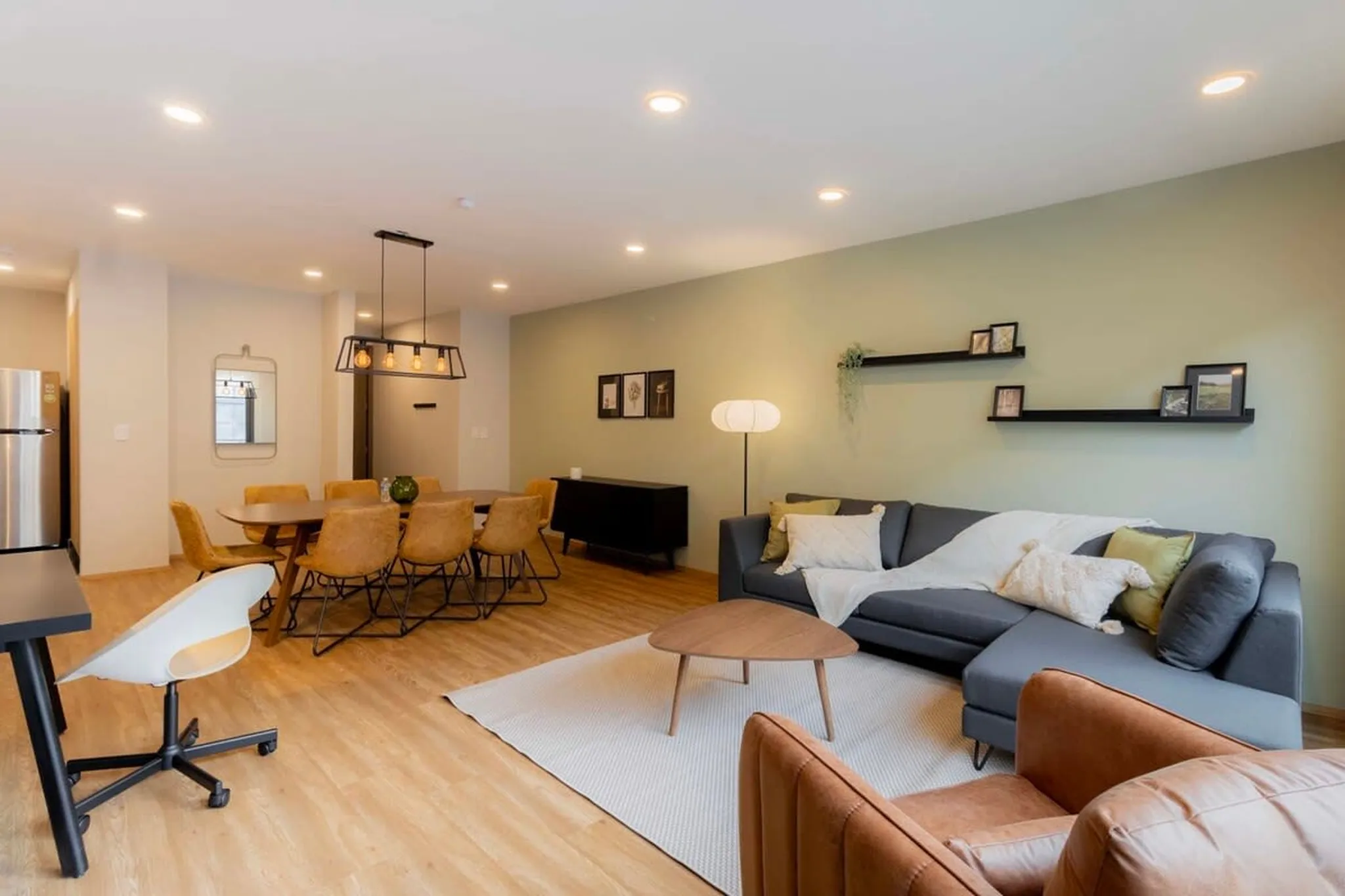 A spacious living room and dining area with a modern design.