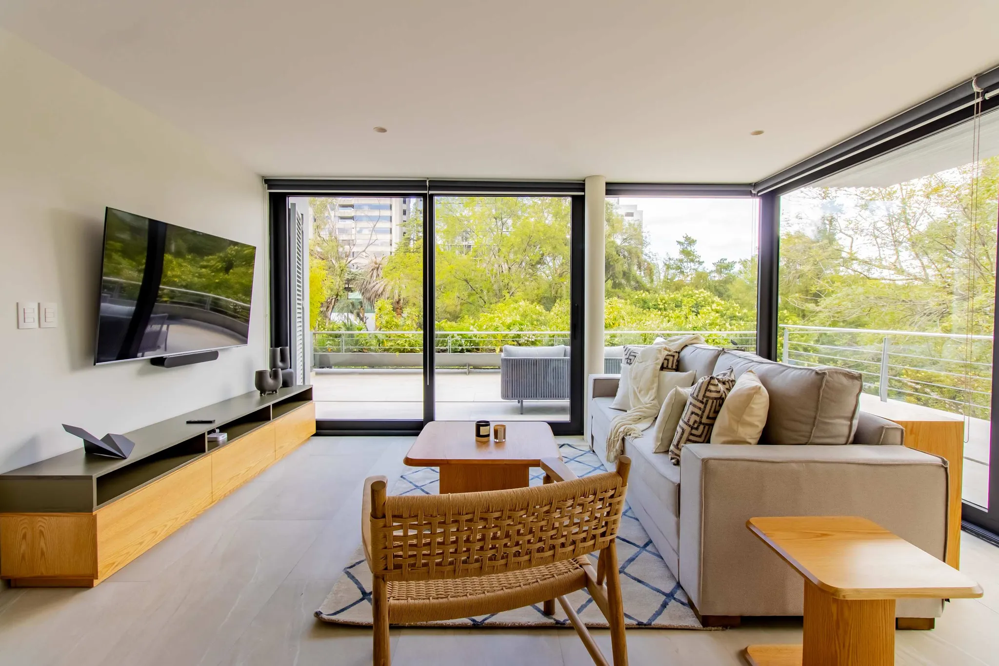 A modern living room with a sofa, coffee table, and a TV.