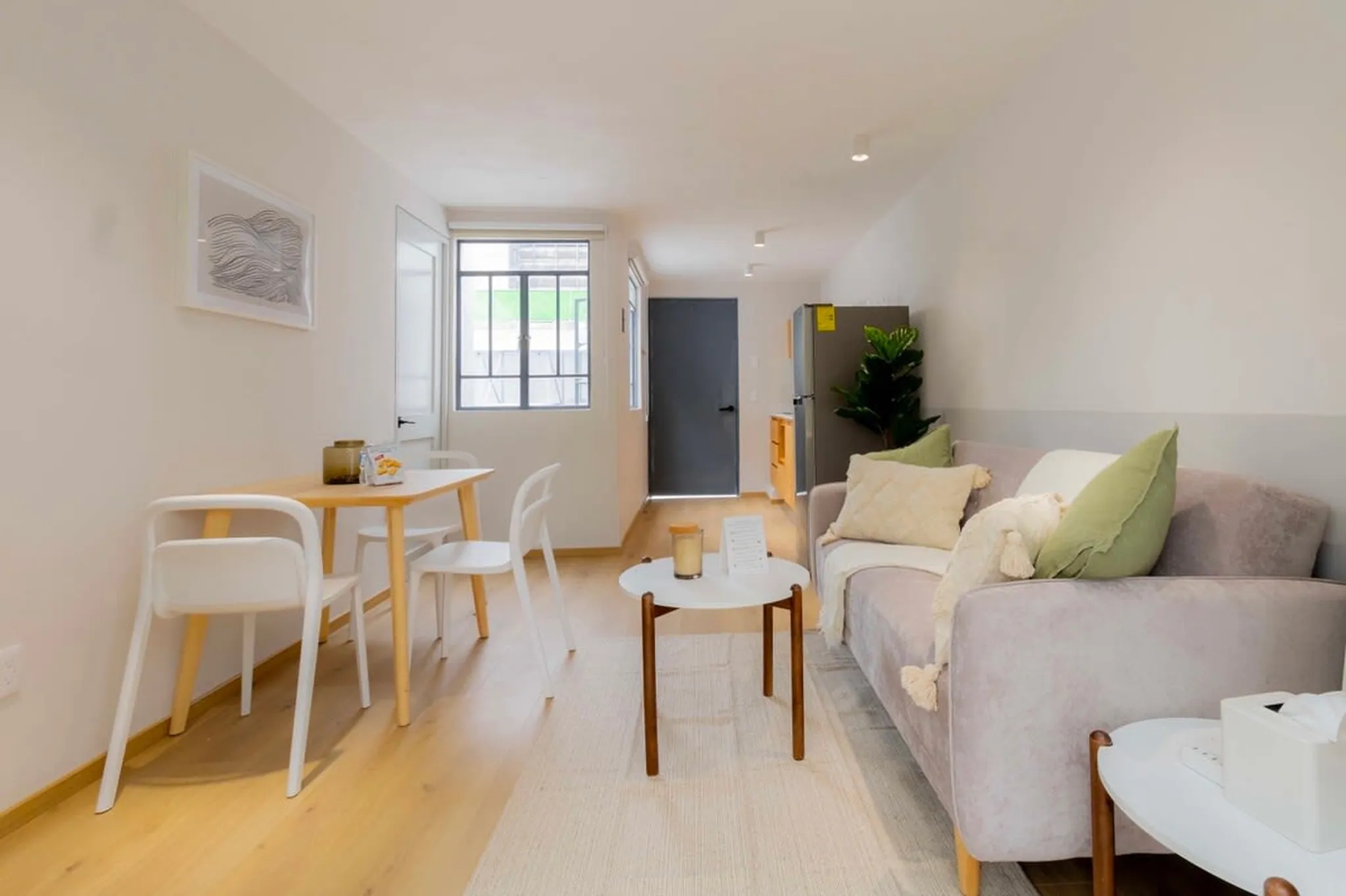A cozy studio apartment with a dining area and living room.