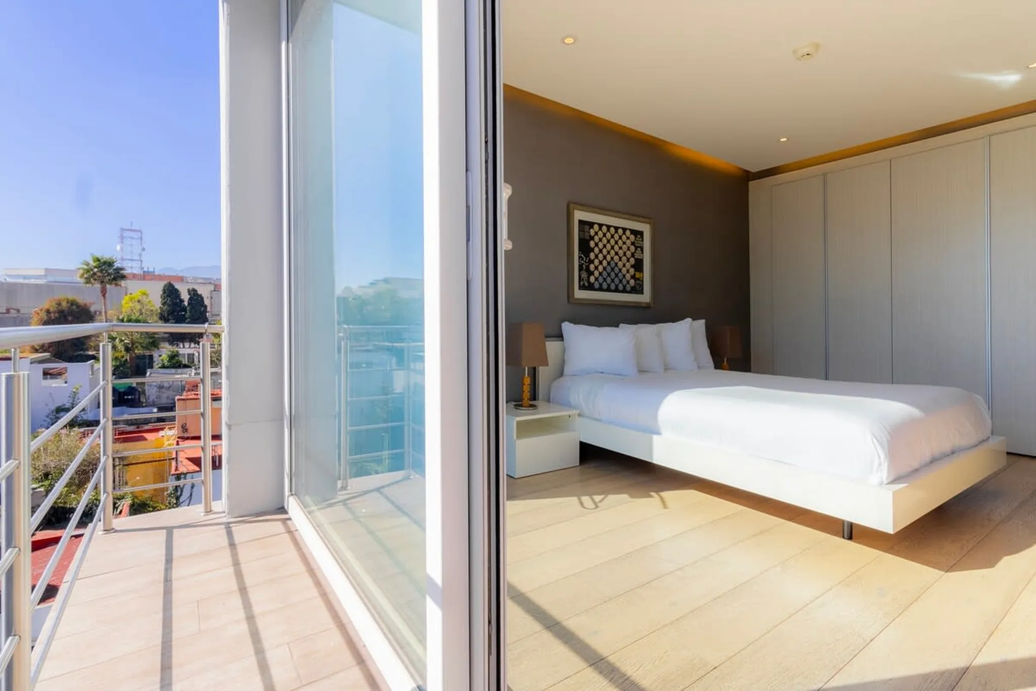 Modern bedroom with a balcony view.