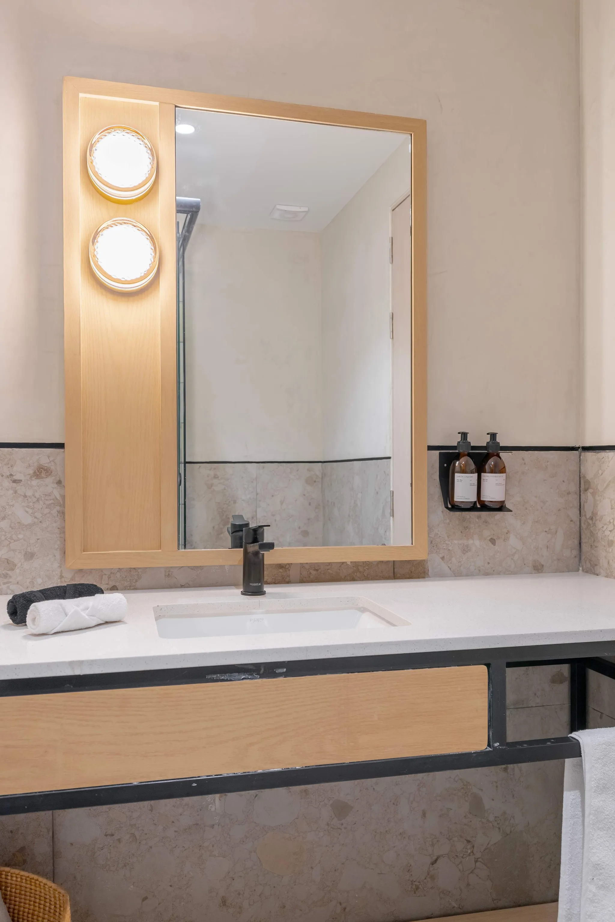 Bathroom vanity with a sink, faucet, mirror, and towels.