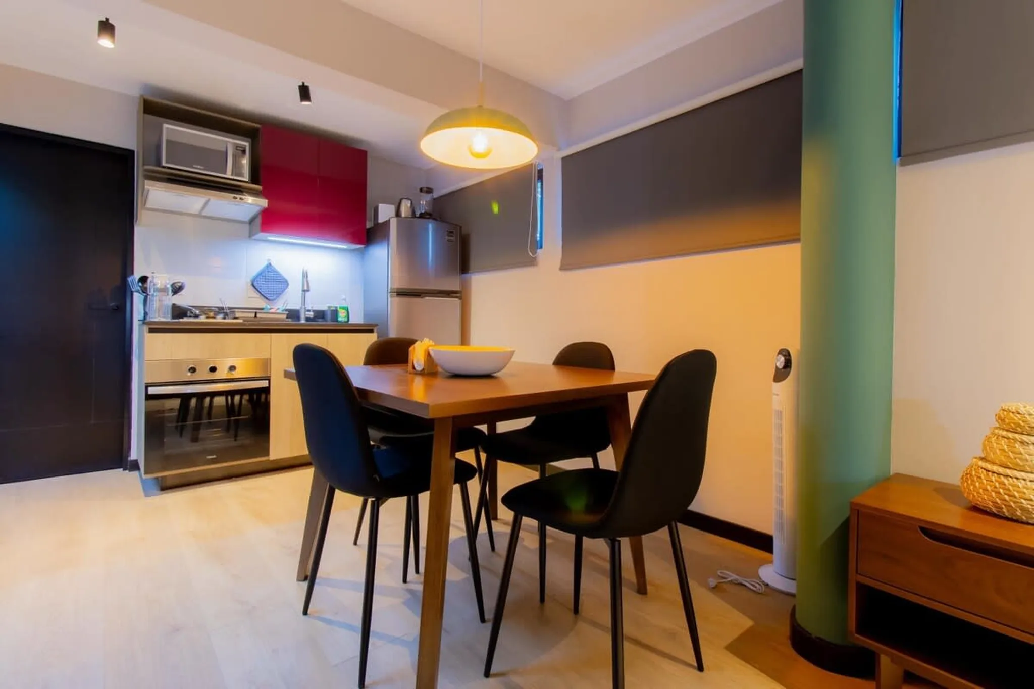A dining table with chairs in a kitchen.
