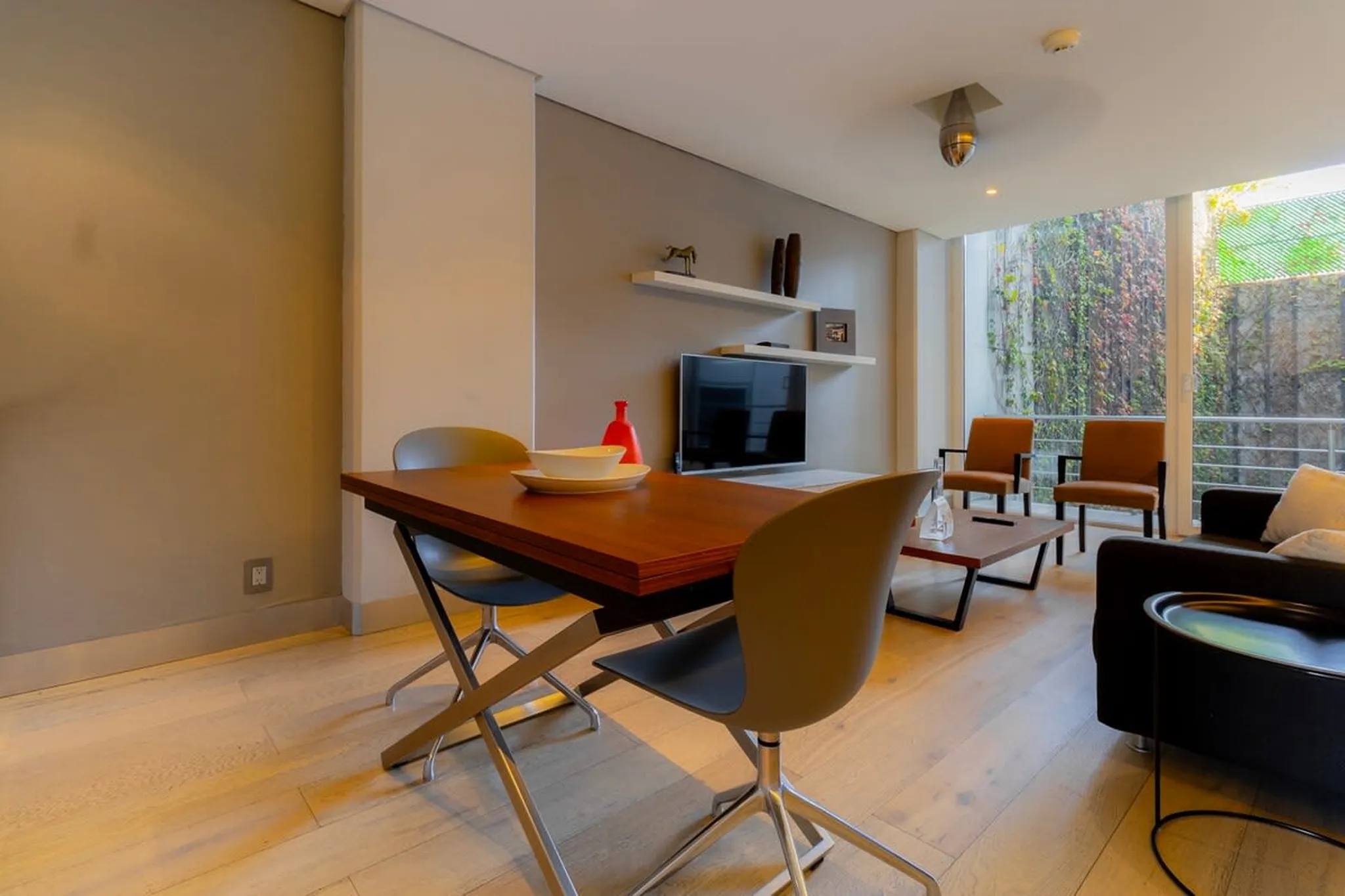 Modern dining area and living room with chairs and a table.