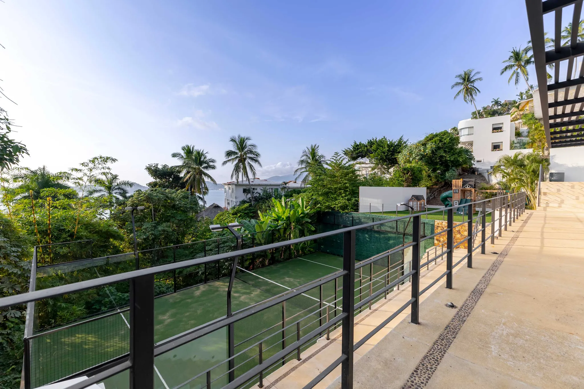 A paddle court is shown next to a tropical resort.