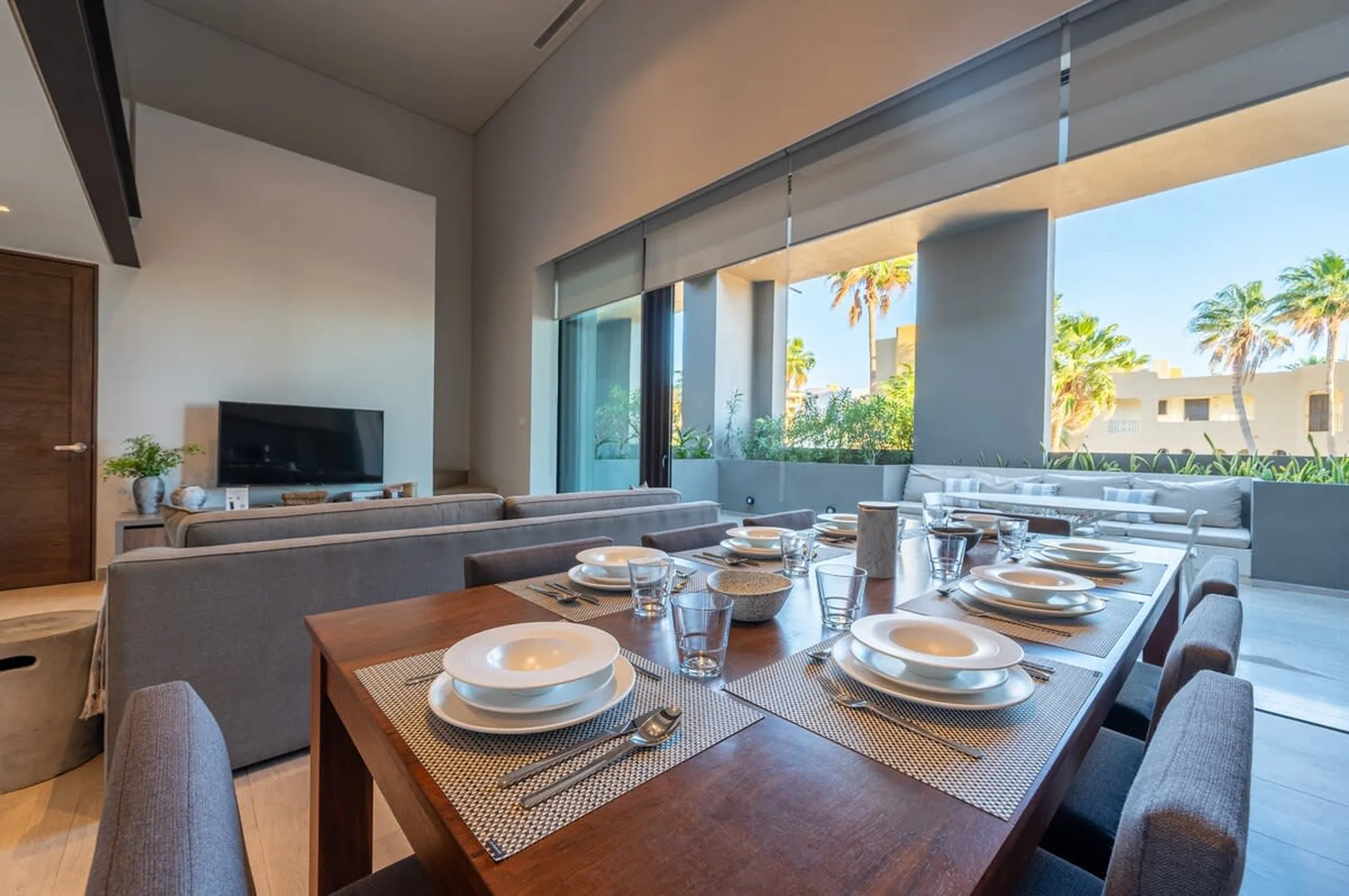 A dining table is set for a meal with plates, glasses, and cutlery.