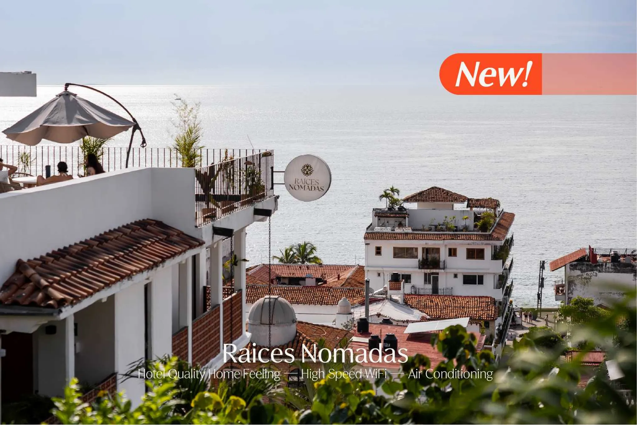 "Raices Nomadas" hotel with a view of the ocean. "New!" banner at the top.