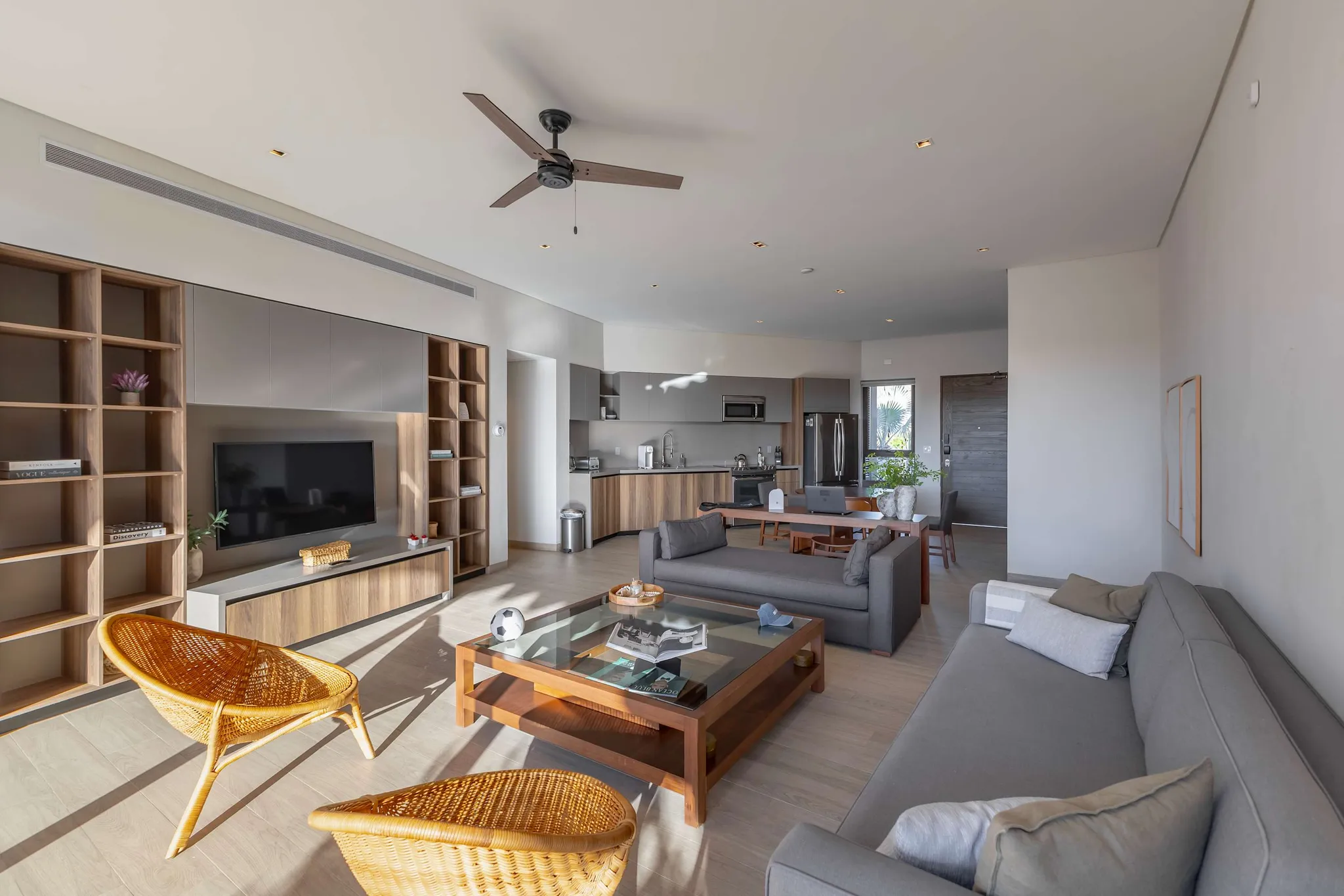 Modern living room with rattan chairs, a sofa, and a coffee table.