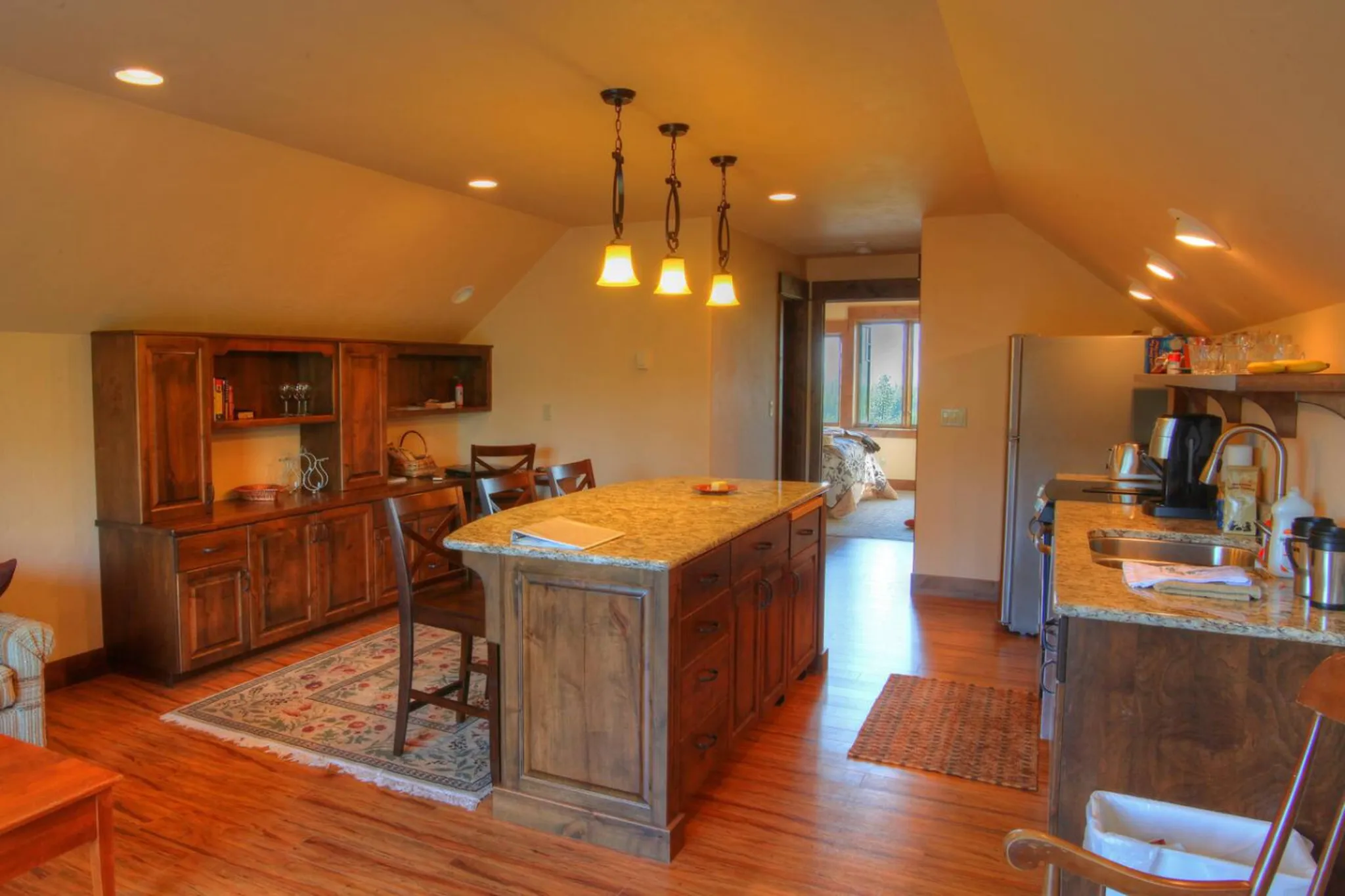 A warm and inviting kitchen with wooden cabinets and a granite island.