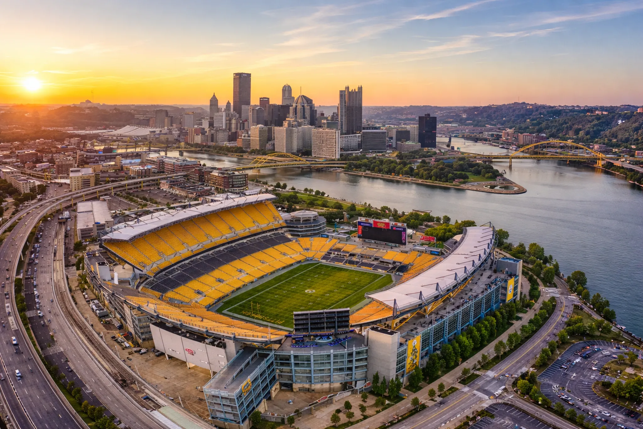 Sunset over Acrisure Stadium and the Pittsburgh skyline