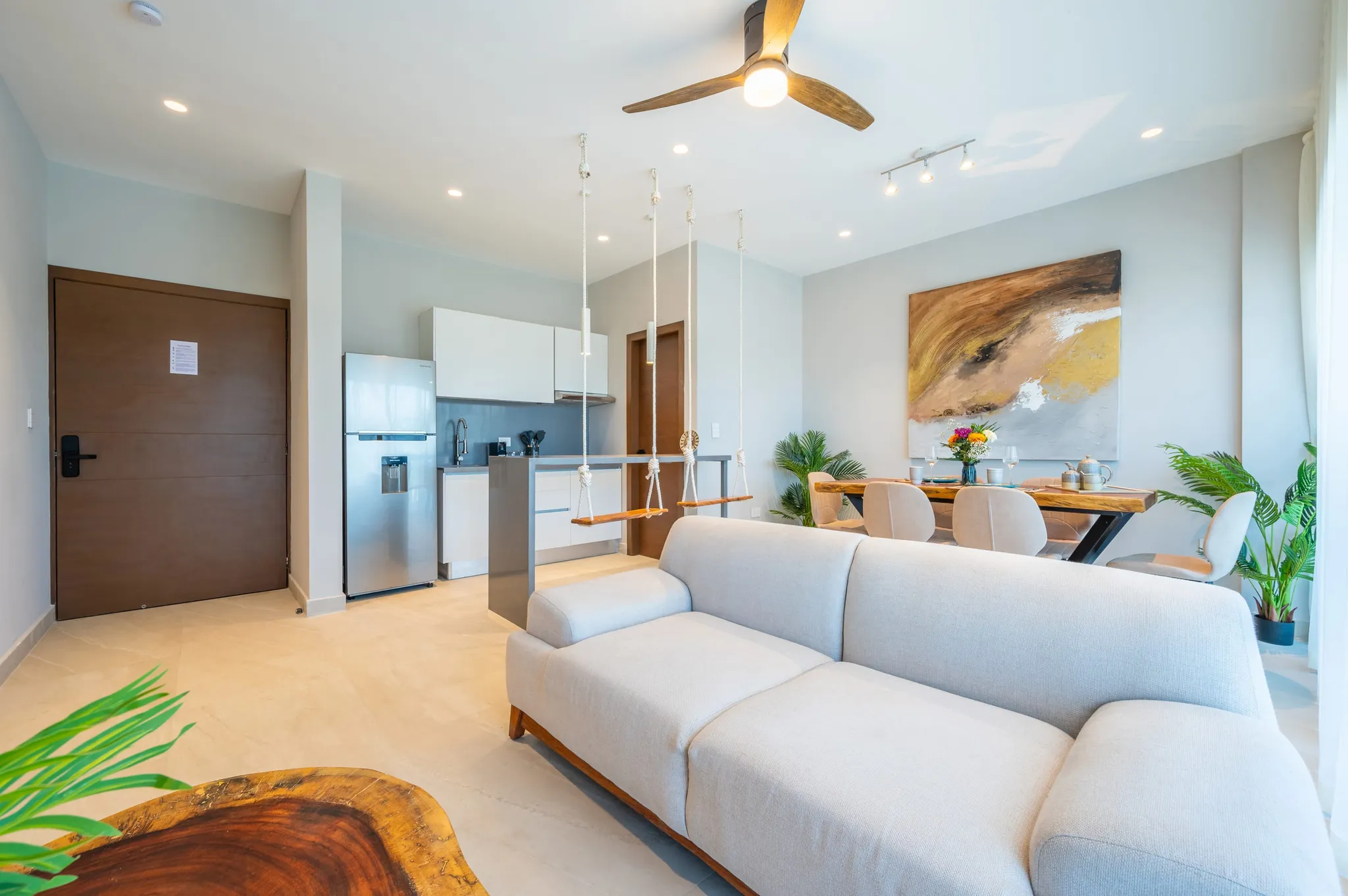 Open-plan living and dining area with swing-style seats at the kitchen breakfast bar