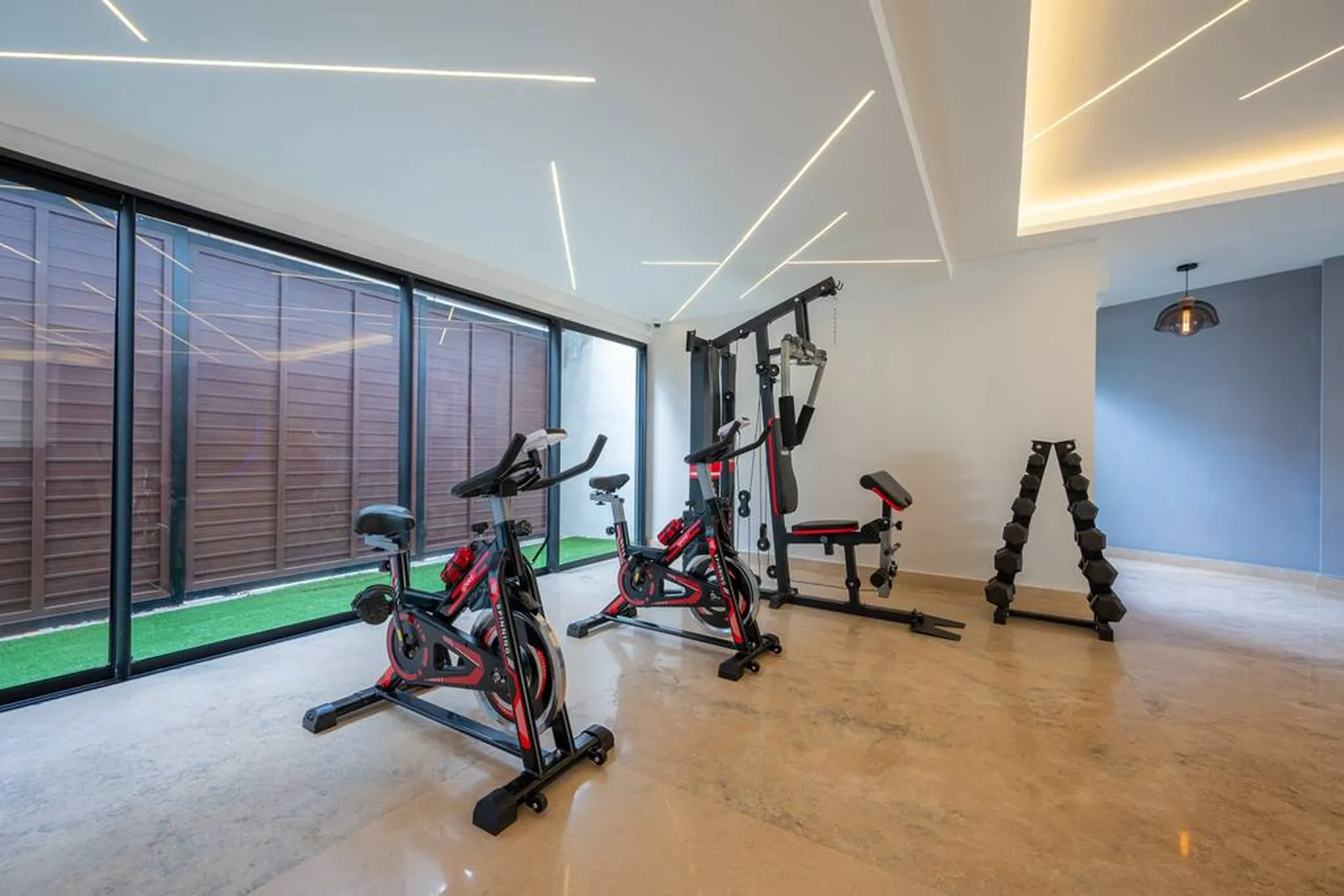 Gym with spin bikes, a weight machine and free weights