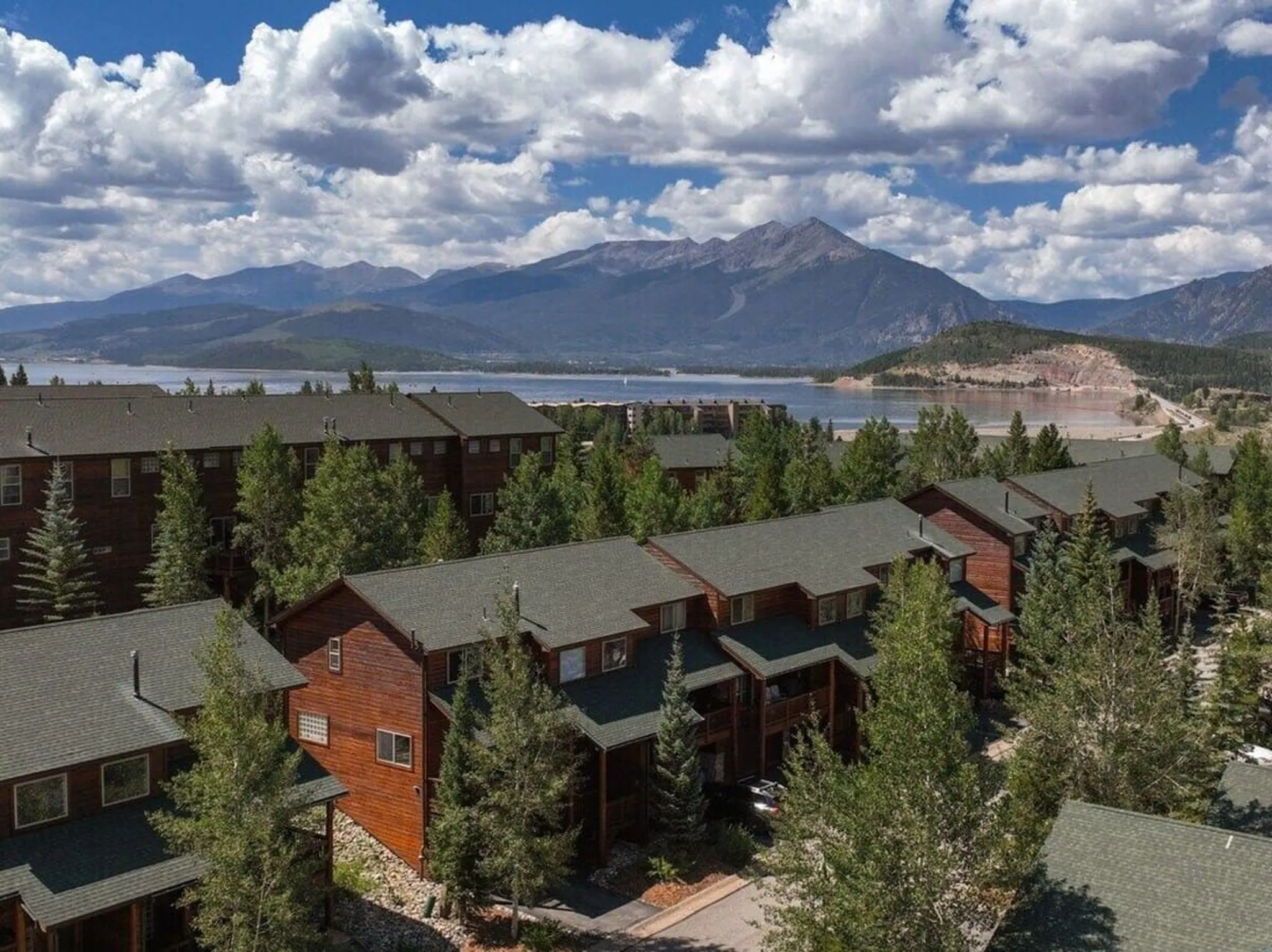 Kayakers on Lake Dillon with sailboats in the marina and mountains behind