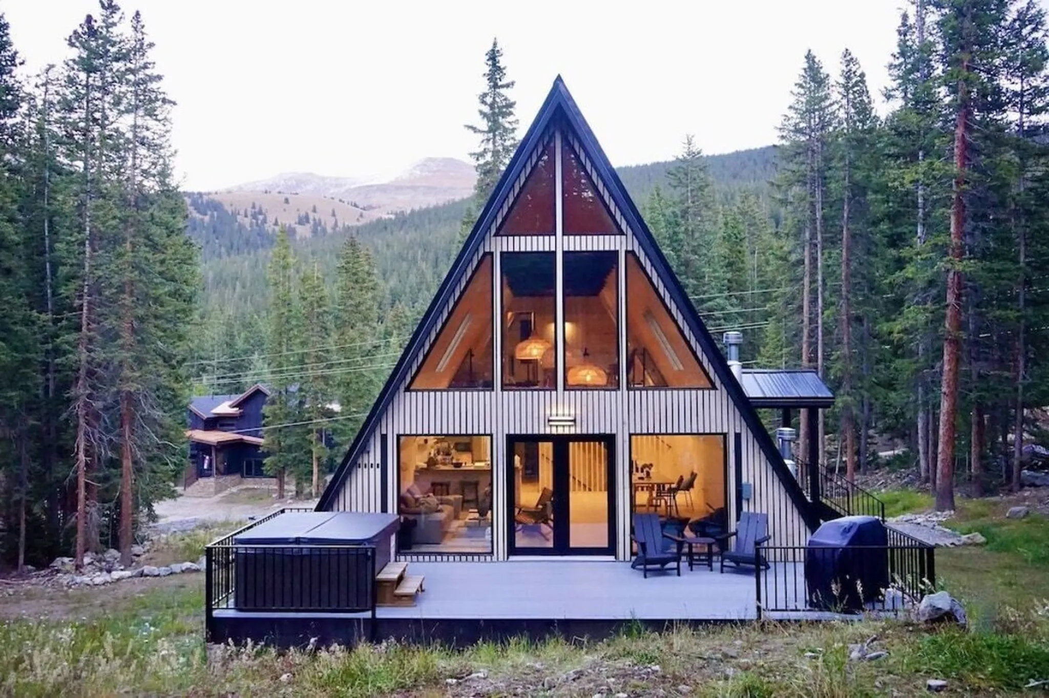 Bhava Cabin, a Luxe Living A-frame in Breckenridge, with its hot tub deck among the pines