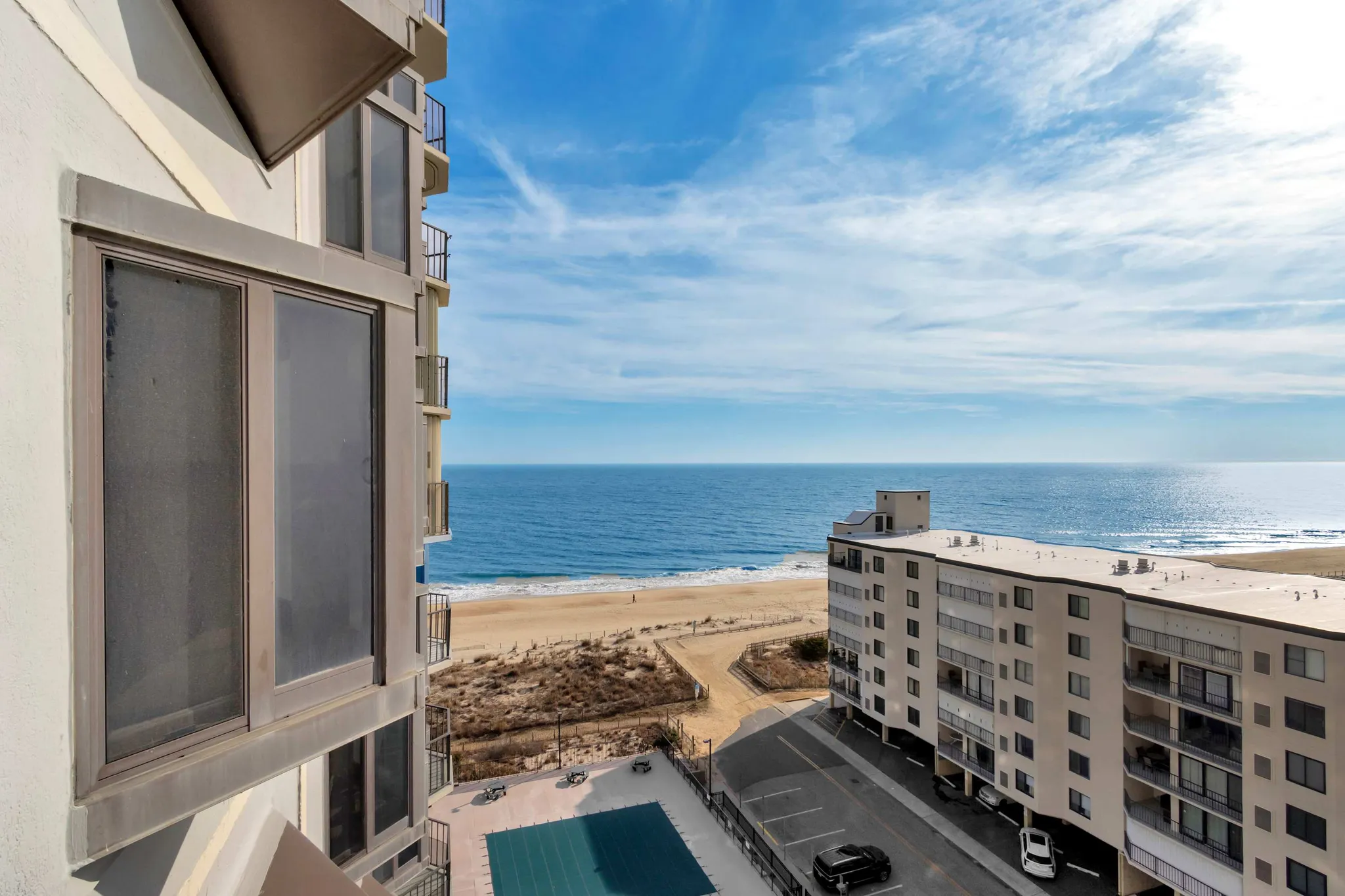 The 9400 Building seen from the beach, with its balconies above the oceanfront pool deck