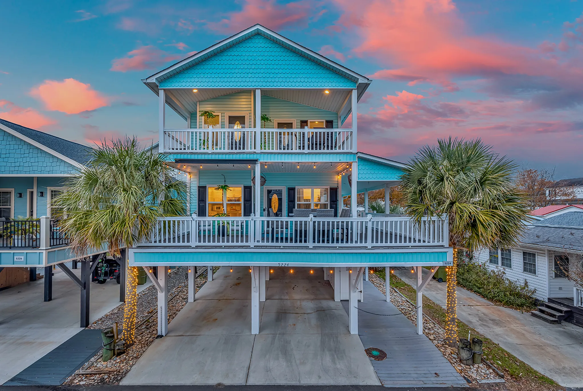 Long covered porch with rocking chairs looking out over the community