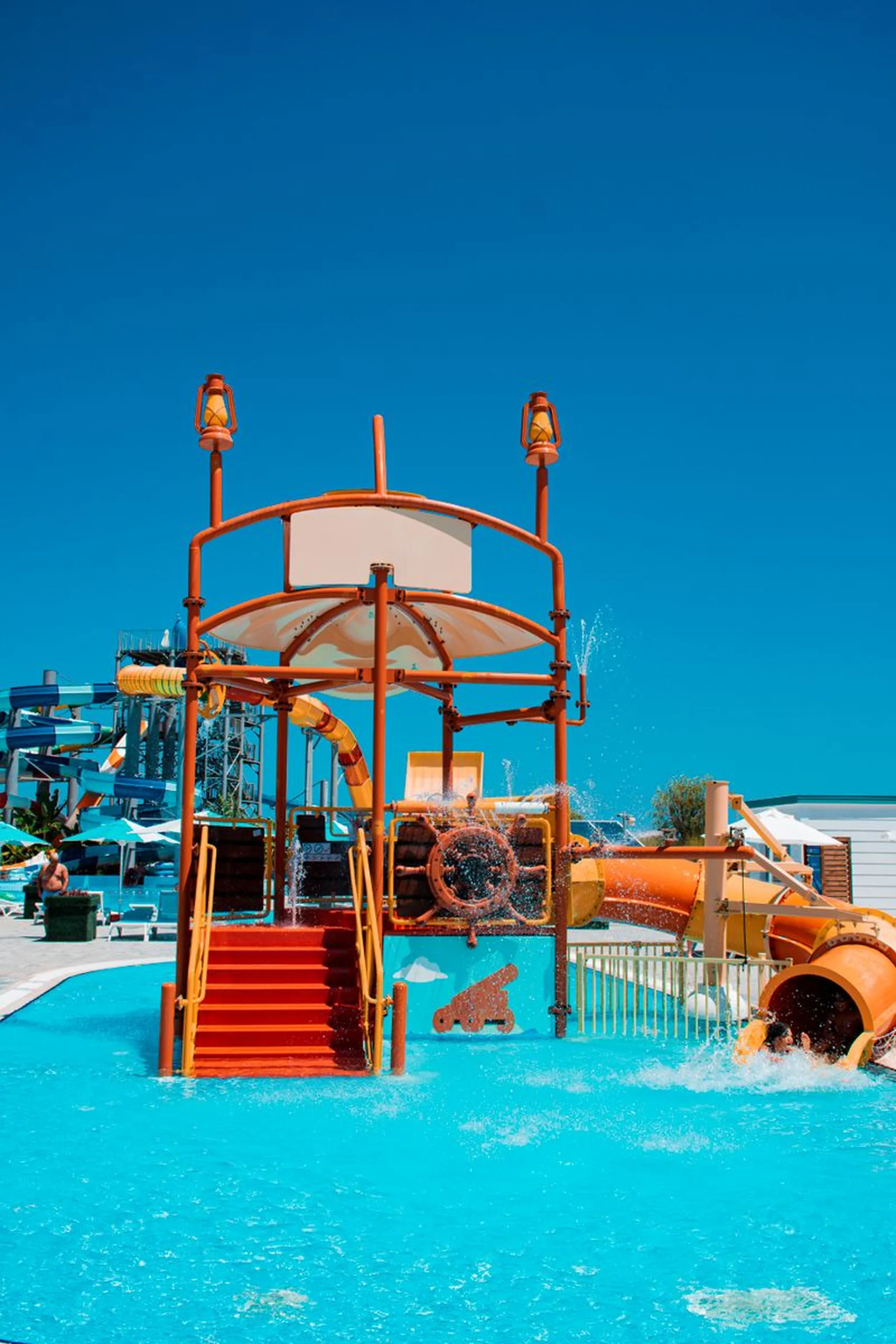 Vibrant water park featuring colorful slides and clear blue skies, perfect for a summer adventure.