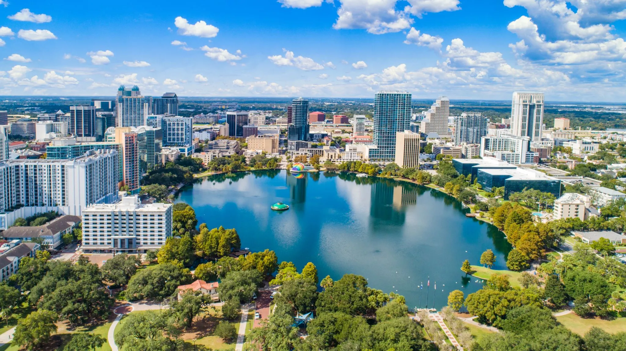 feature photo of Orlando Area, lake and building shown from distance