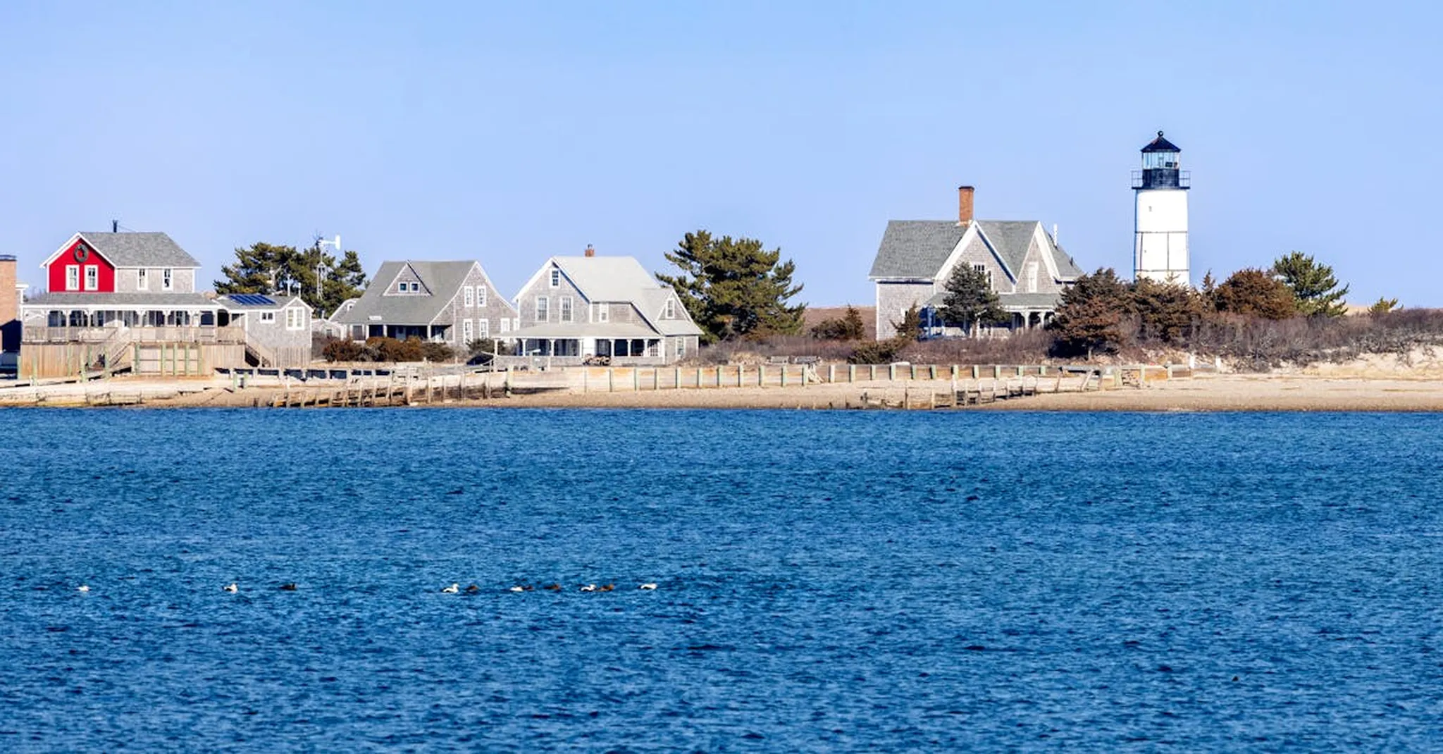 Lighthouse and harbor homes on Cape Cod