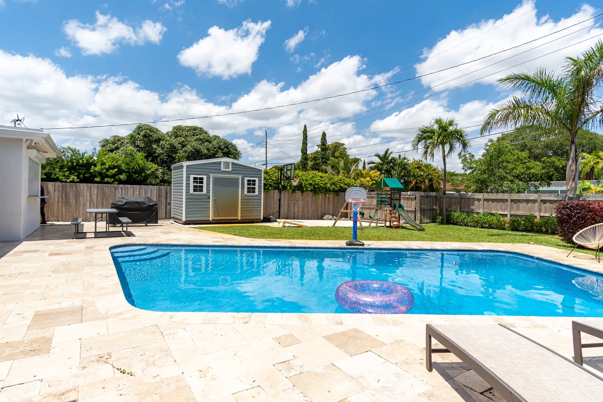 The heated pool and sun deck under a clear South Florida sky