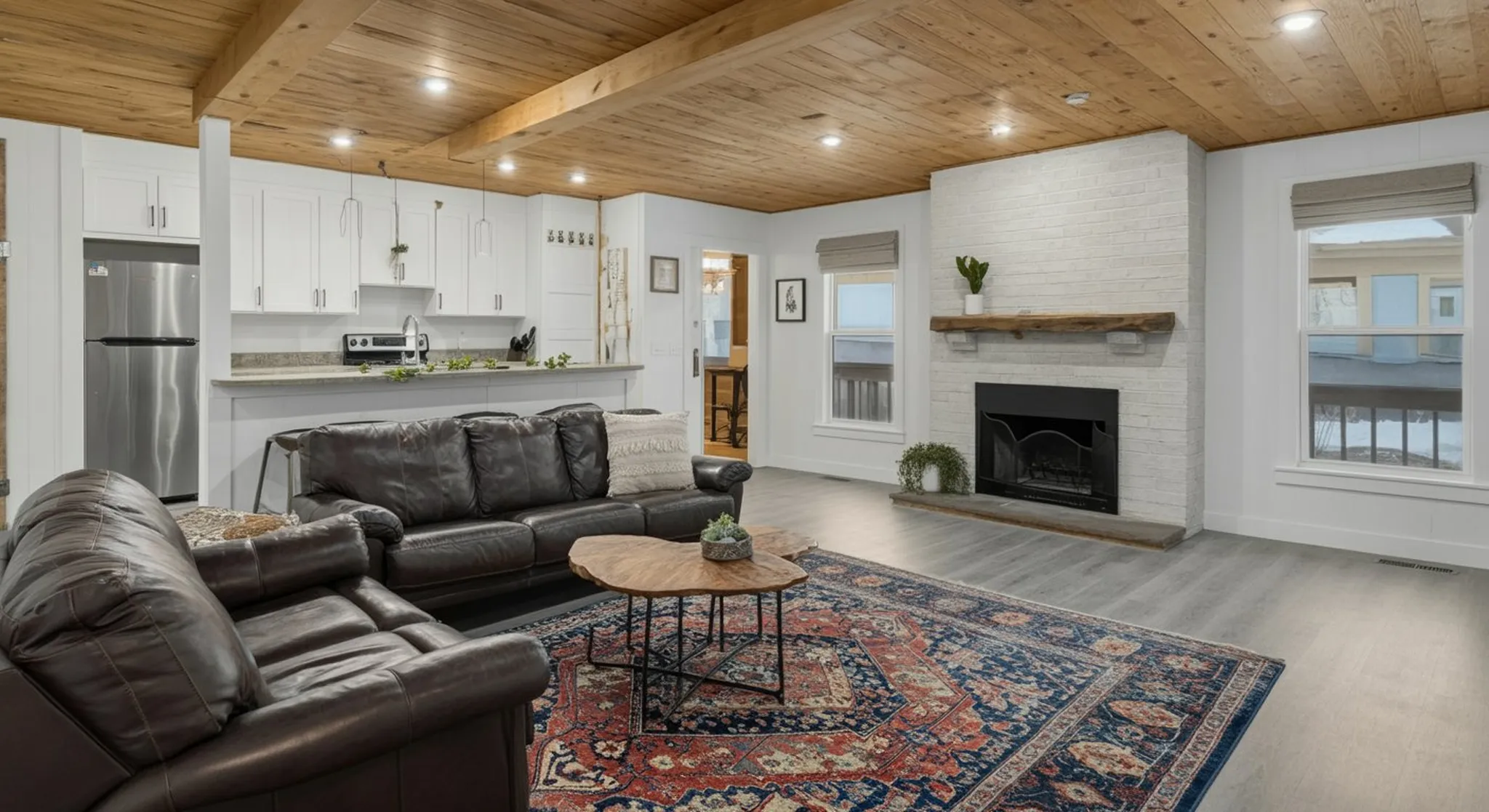Wide atmospheric establishing shot of be our guest housing — sense of place, evocative, no people in foreground, no signage, no text overlays. Bright daylight real-estate interior photograph, wide-ang