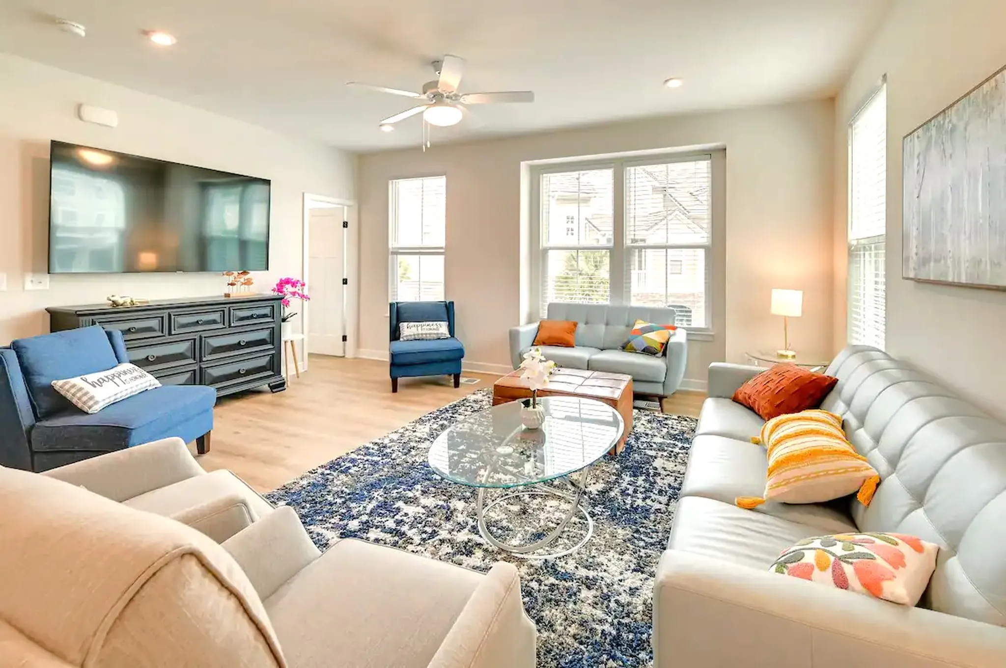 Open living room with twin blue sofas and room for the whole crew