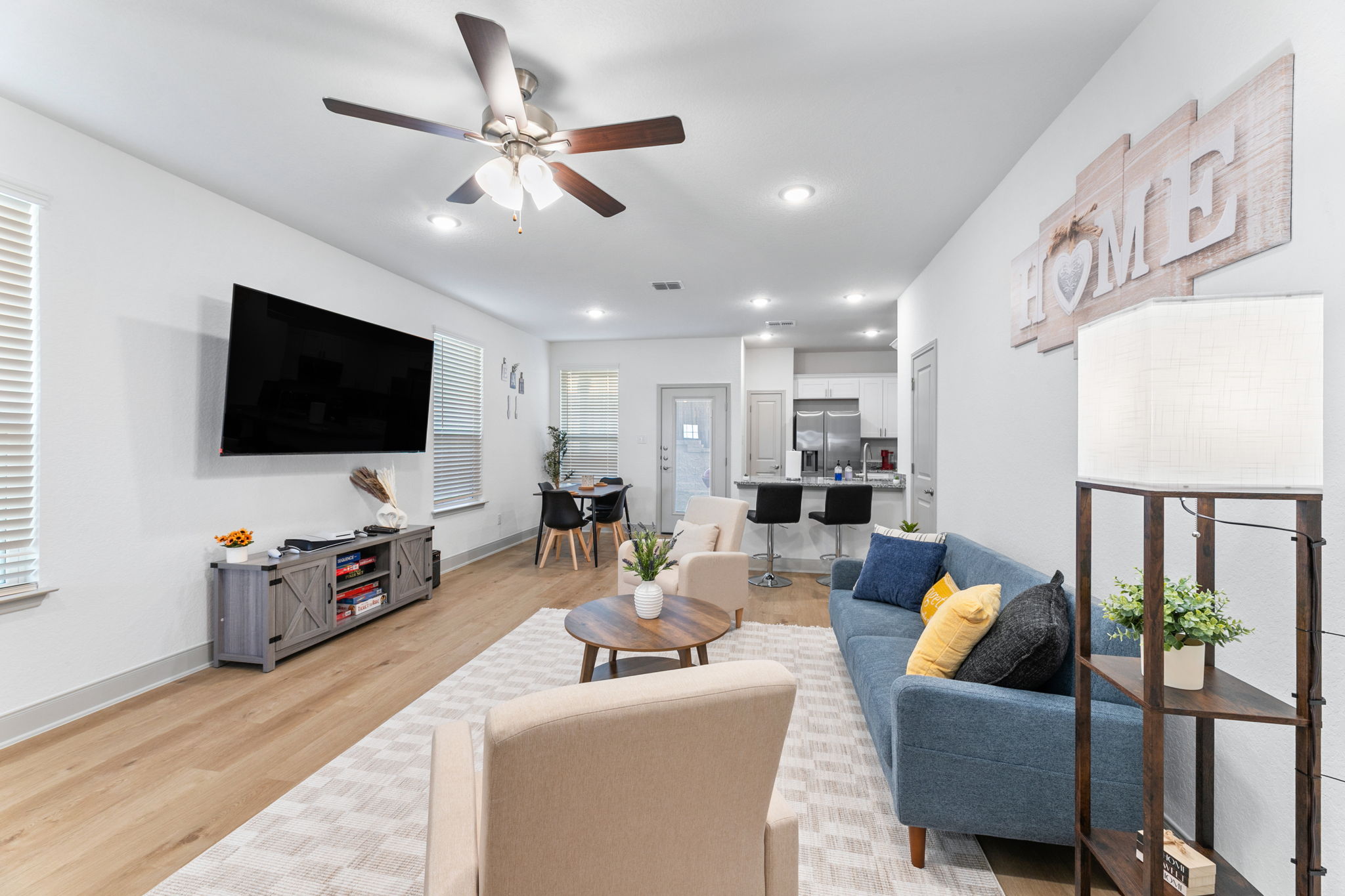 Bright open living room with a big-screen TV in a gated San Antonio duplex