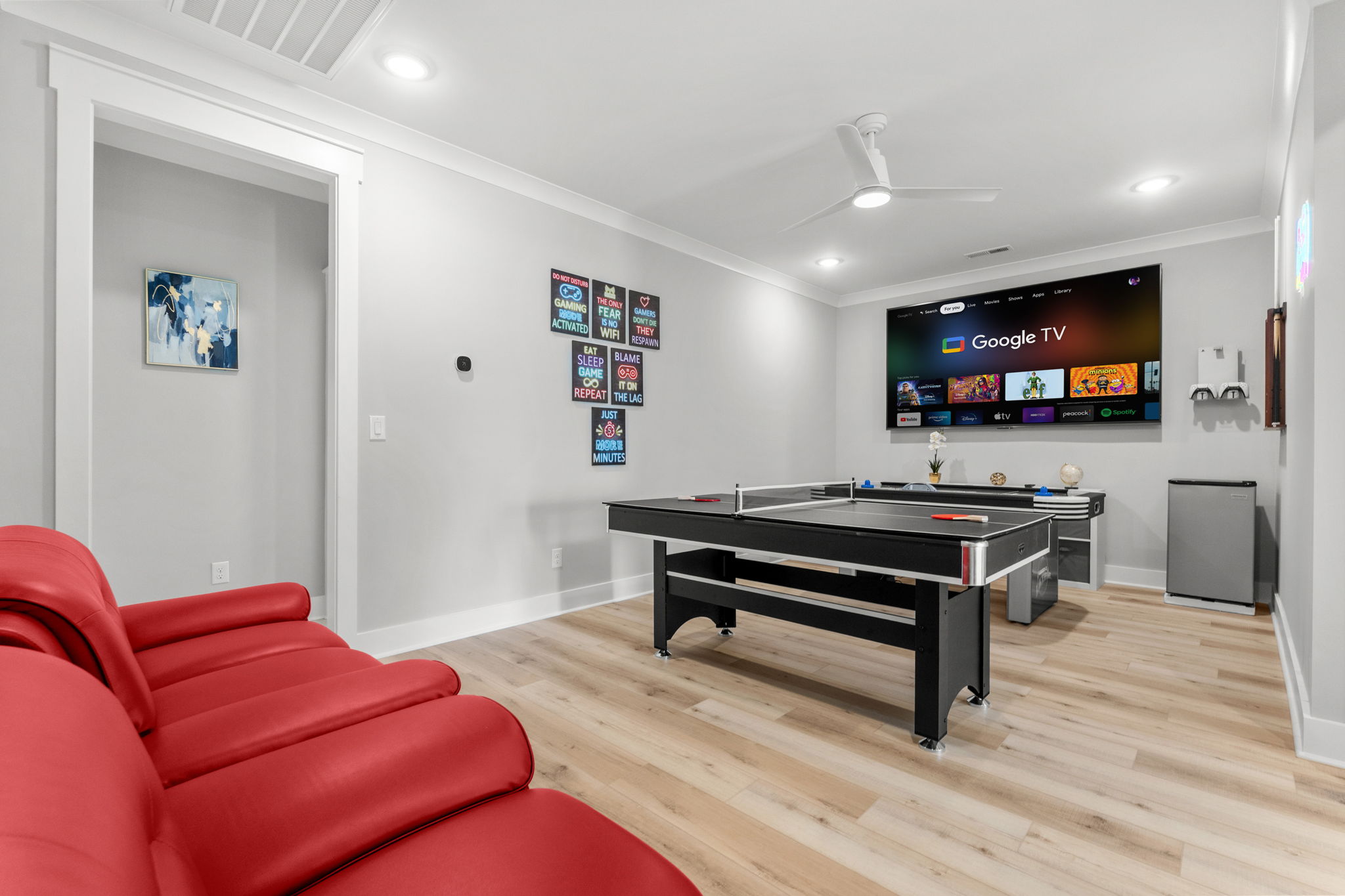 Game room with pool table and red sectional
