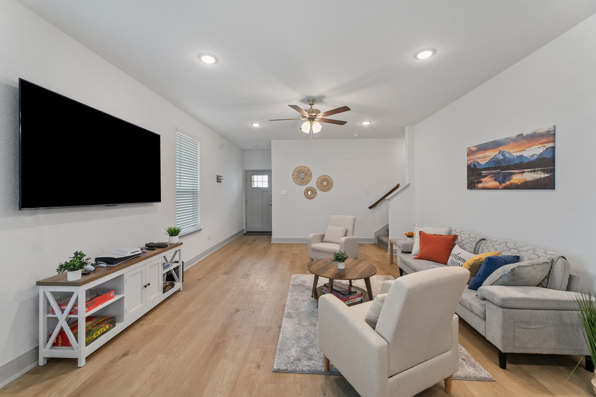 Living room with a wall-sized TV, built for movie night