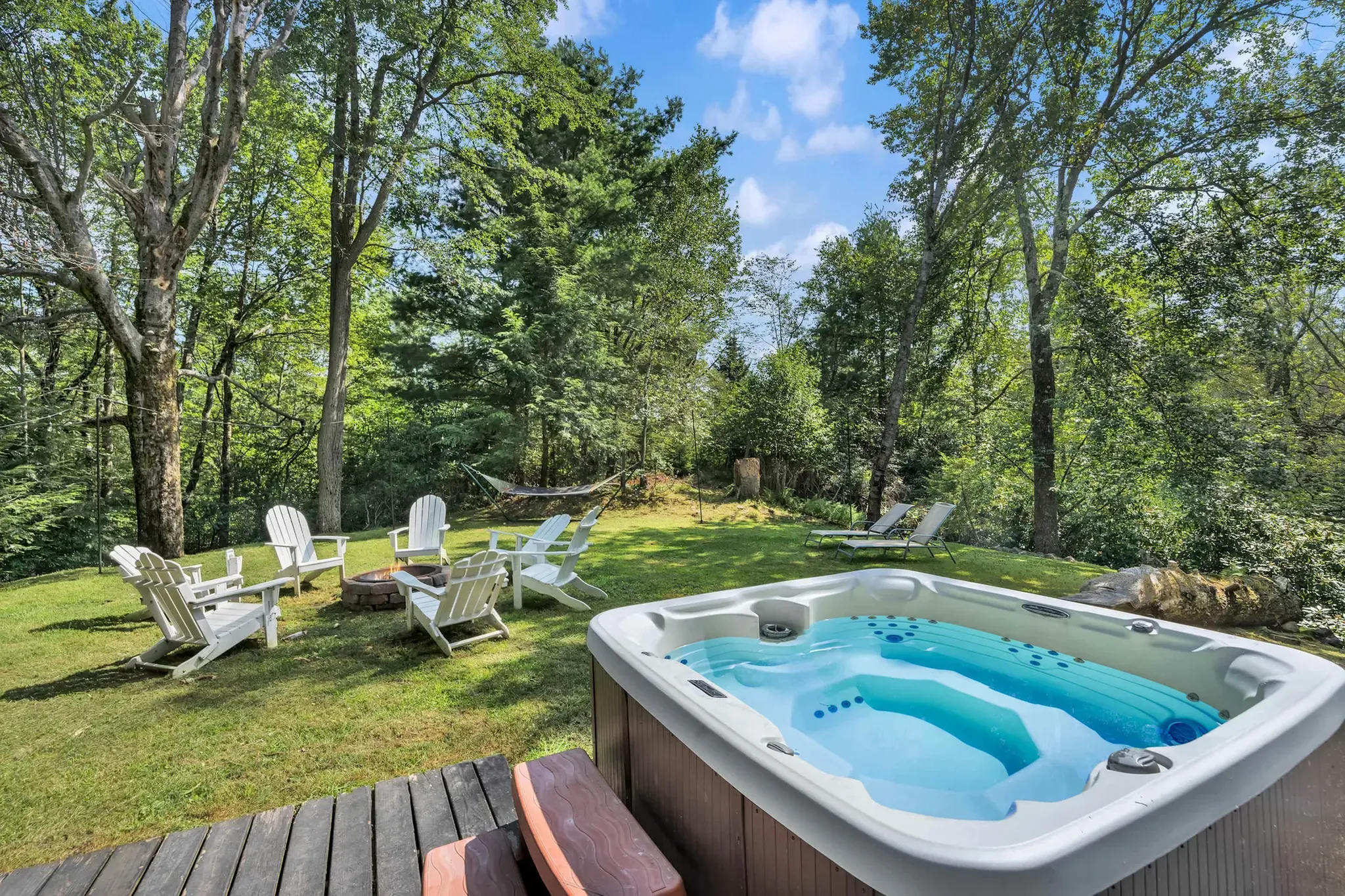 Private hot tub on a secluded deck surrounded by trees at a Poconos vacation home