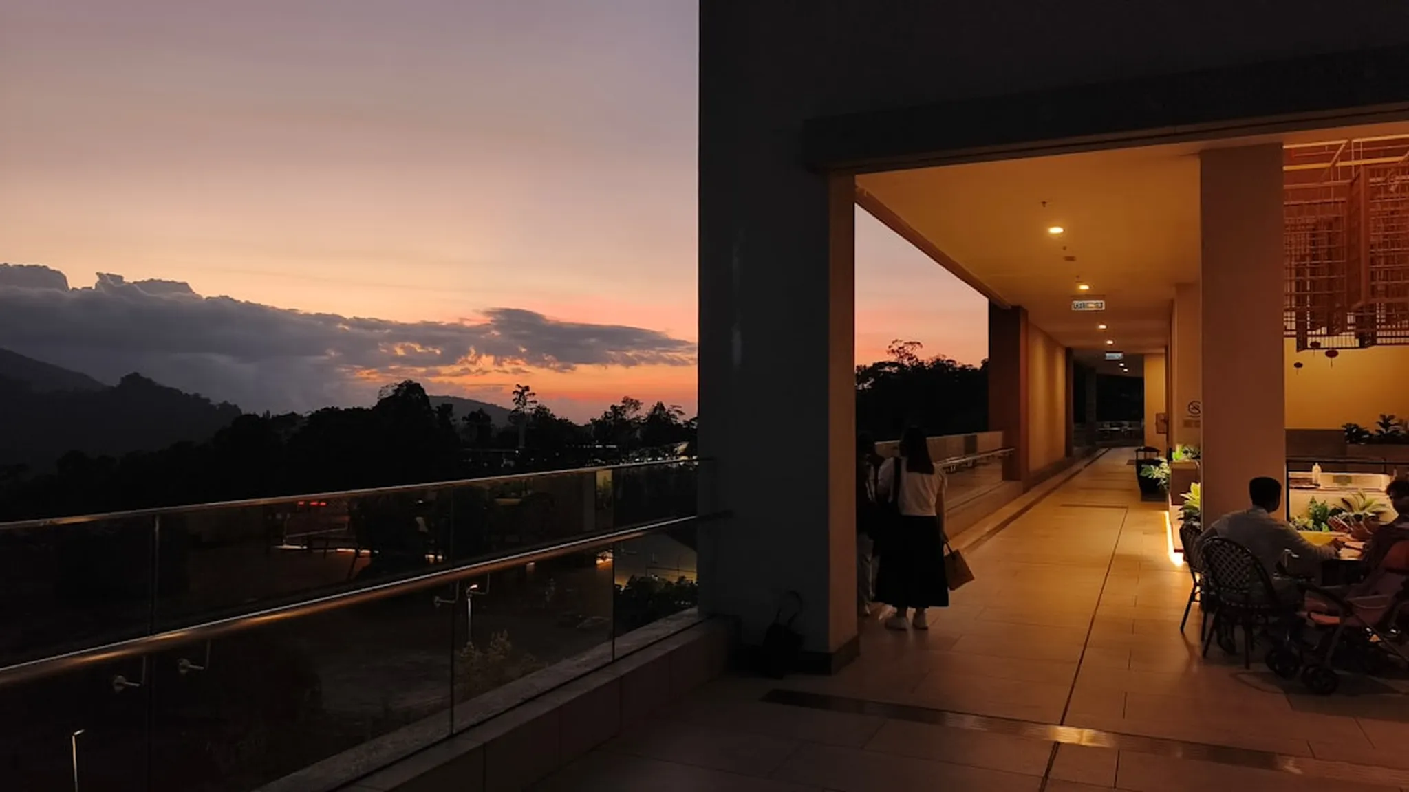 Sunset over mountains with a covered walkway