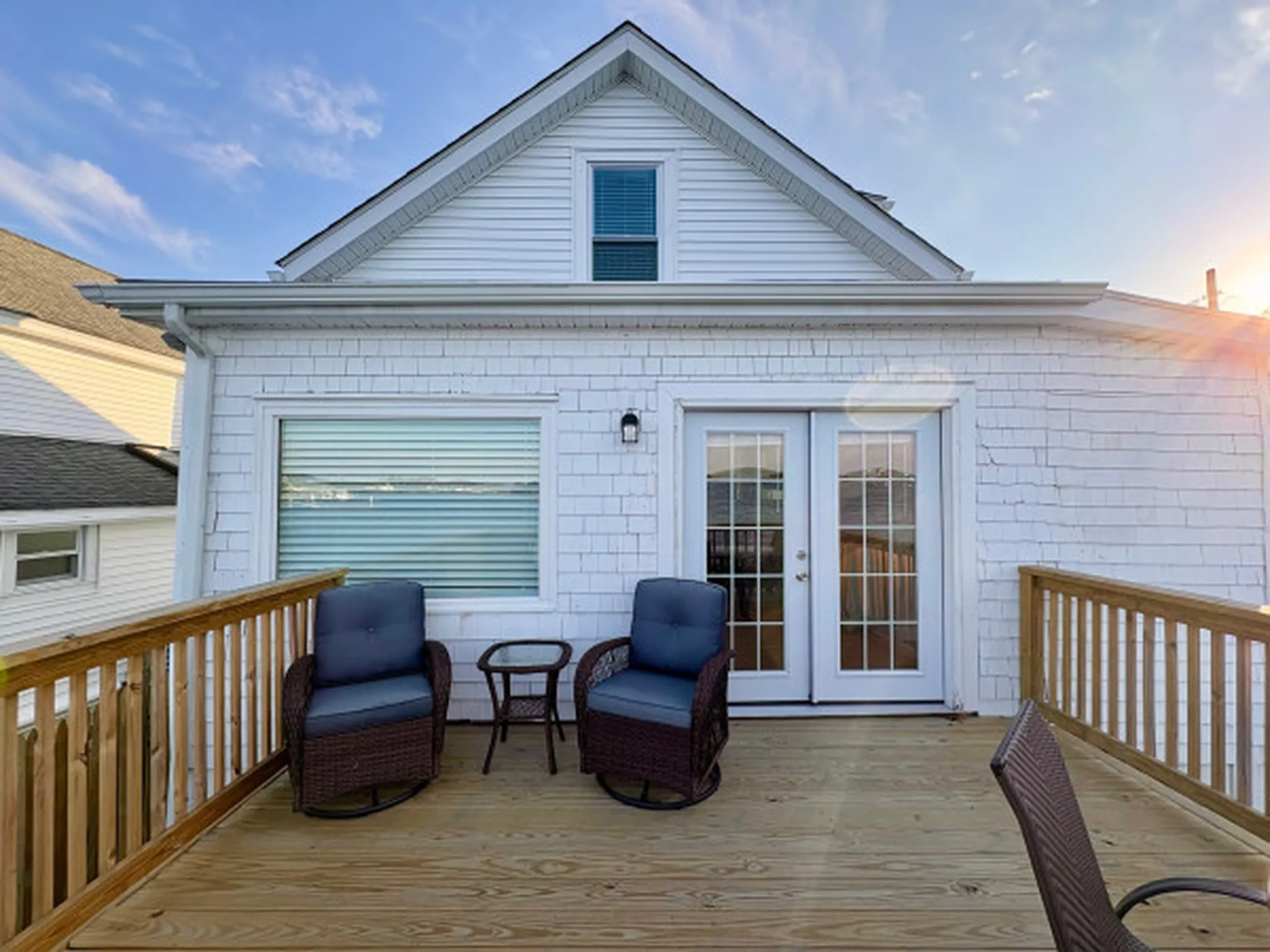 Wide atmospheric establishing shot of ocean vista bnb — sense of place, evocative, no people in foreground, no signage, no text overlays. Geographic setting: multi-region coastal — New England harbor