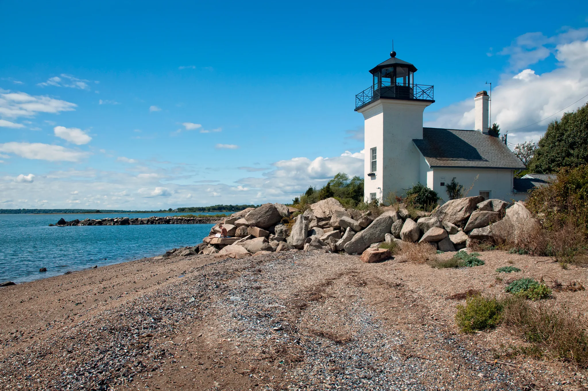 Wide atmospheric establishing shot of ocean vista bnb — sense of place, evocative, no people in foreground, no signage, no text overlays. Geographic setting: multi-region coastal — New England harbor
