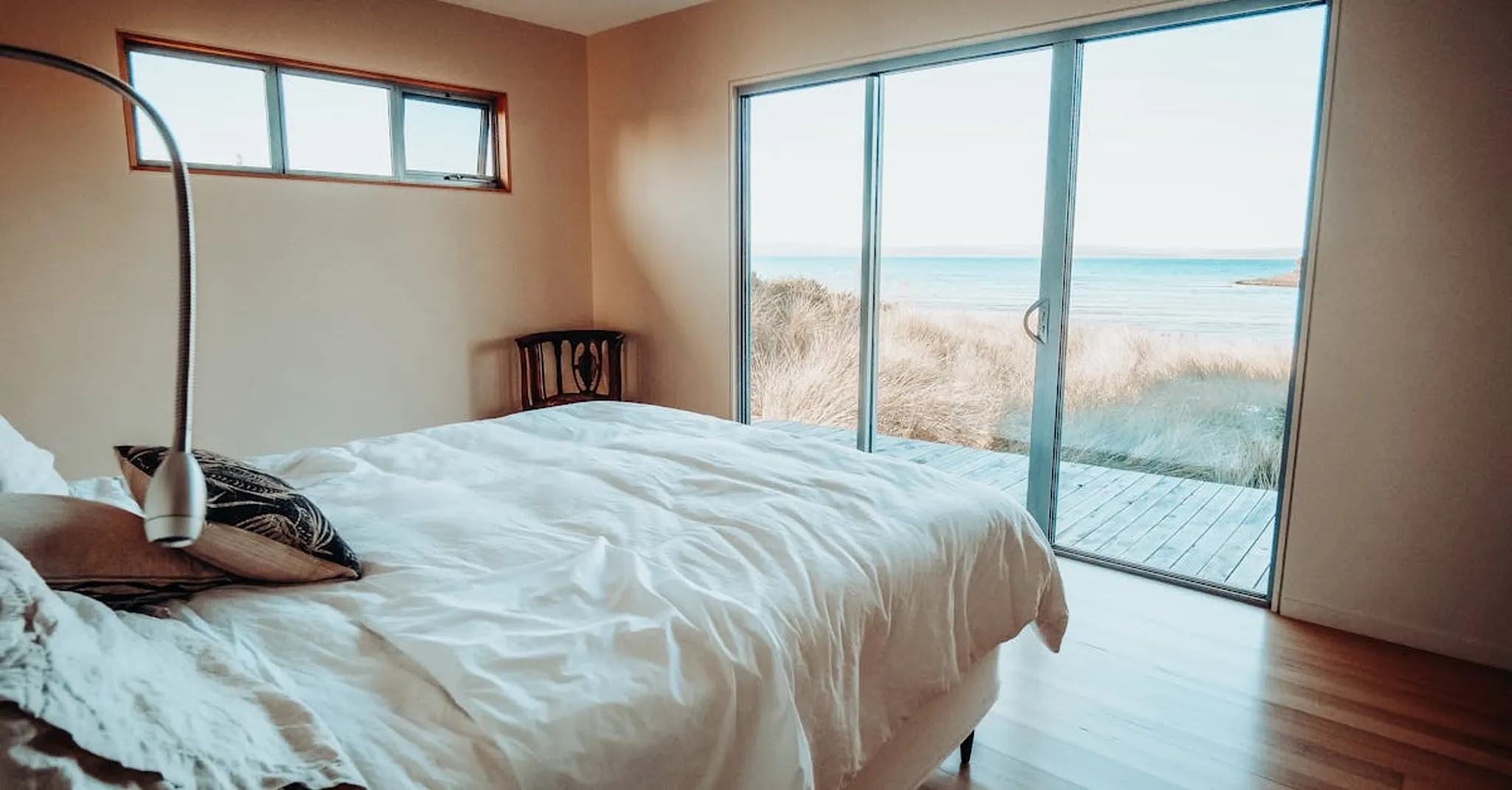 Relax in a serene bedroom overlooking the ocean, perfect for unwinding.